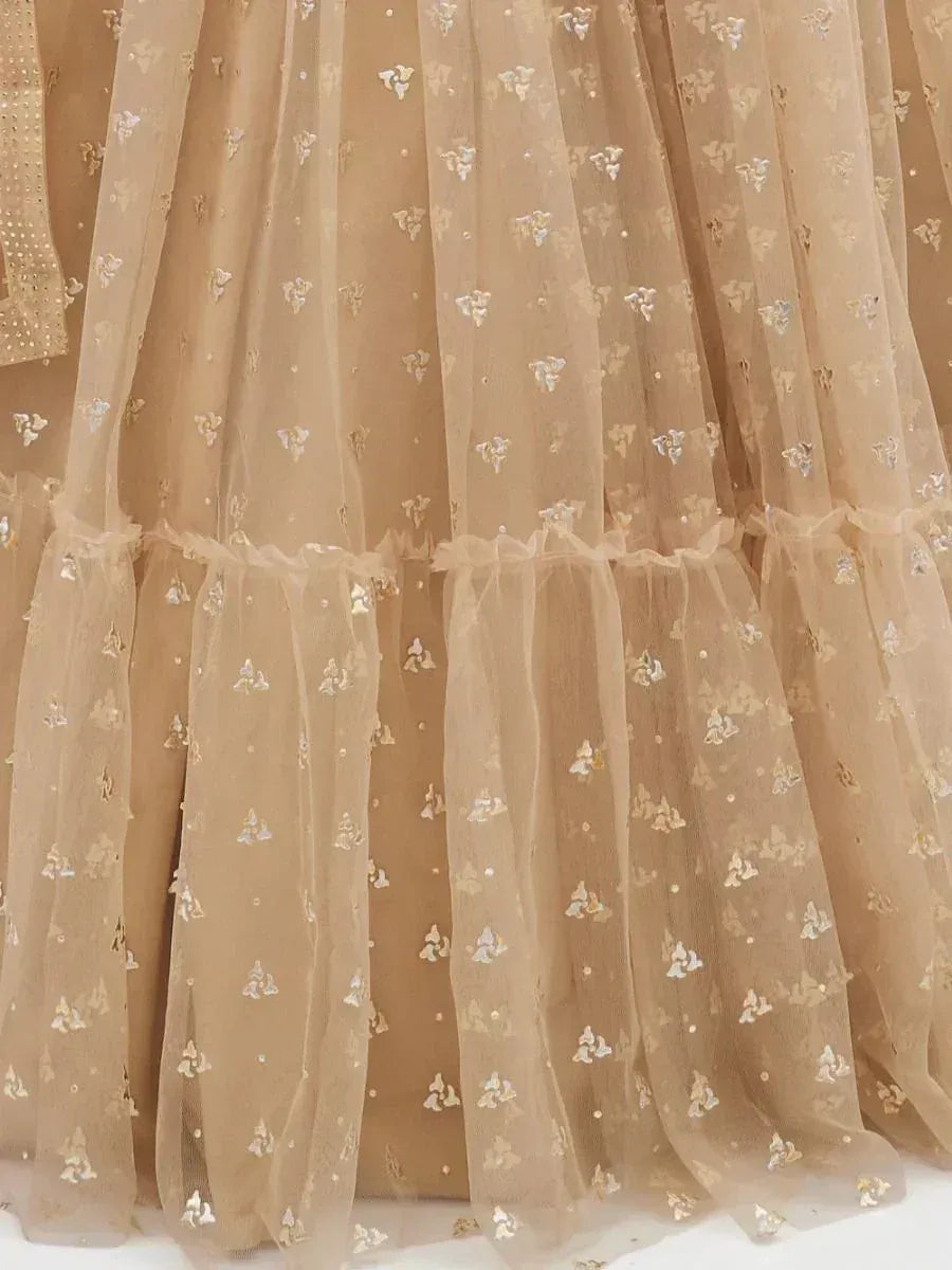 Beige sheer lehenga with floral sequin embroidery and ruffled tiers, perfect for ethnic wear.