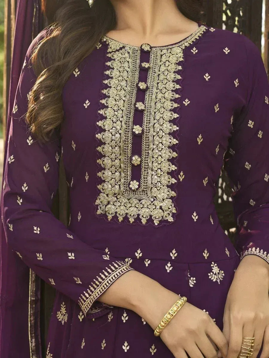 Purple embroidered salwar kameez with gold thread work and floral motifs, perfect for ethnic occasions.