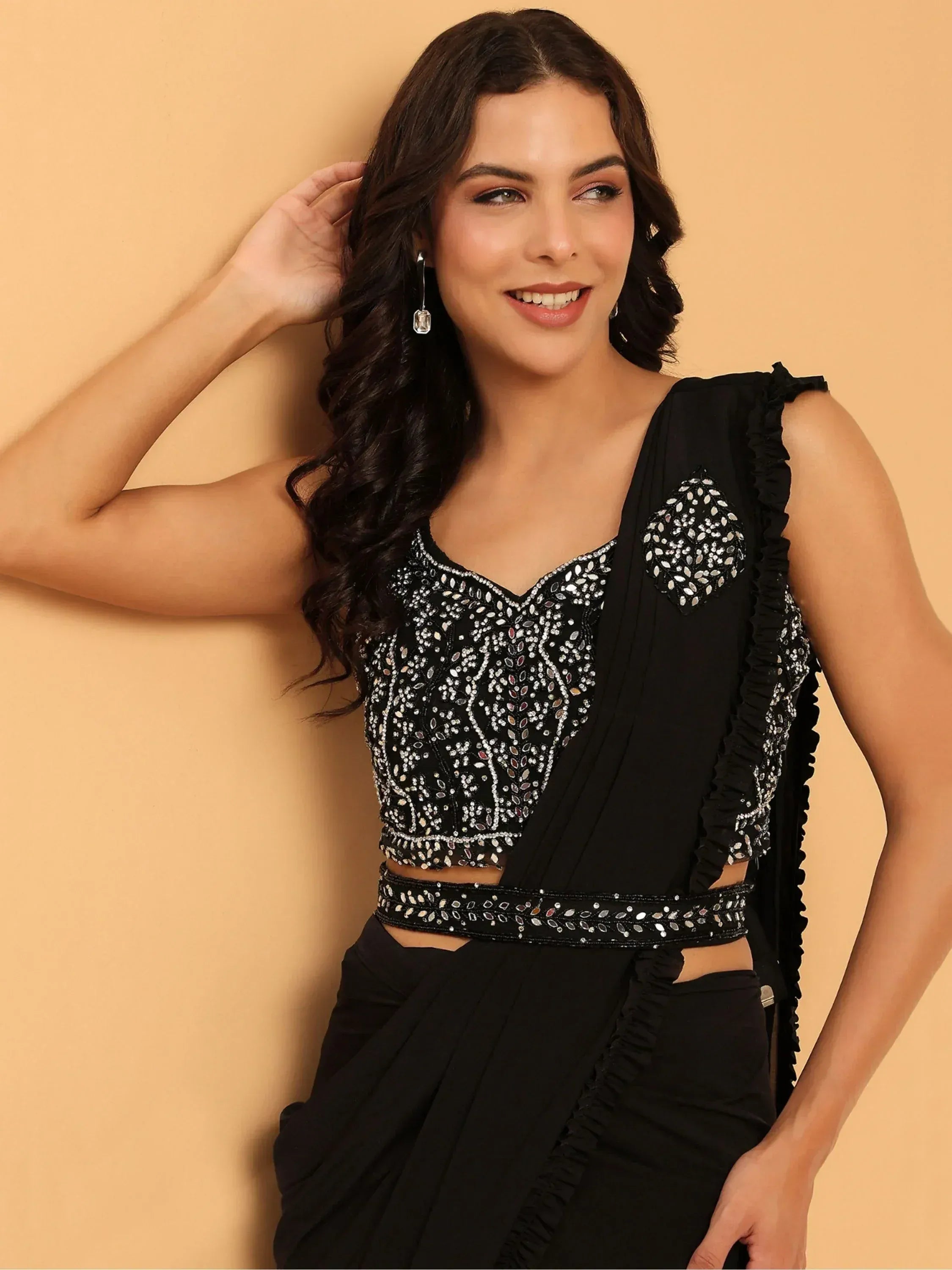 Black designer saree with heavy mirror work and ruffled sleeves, perfect for ethnic occasions