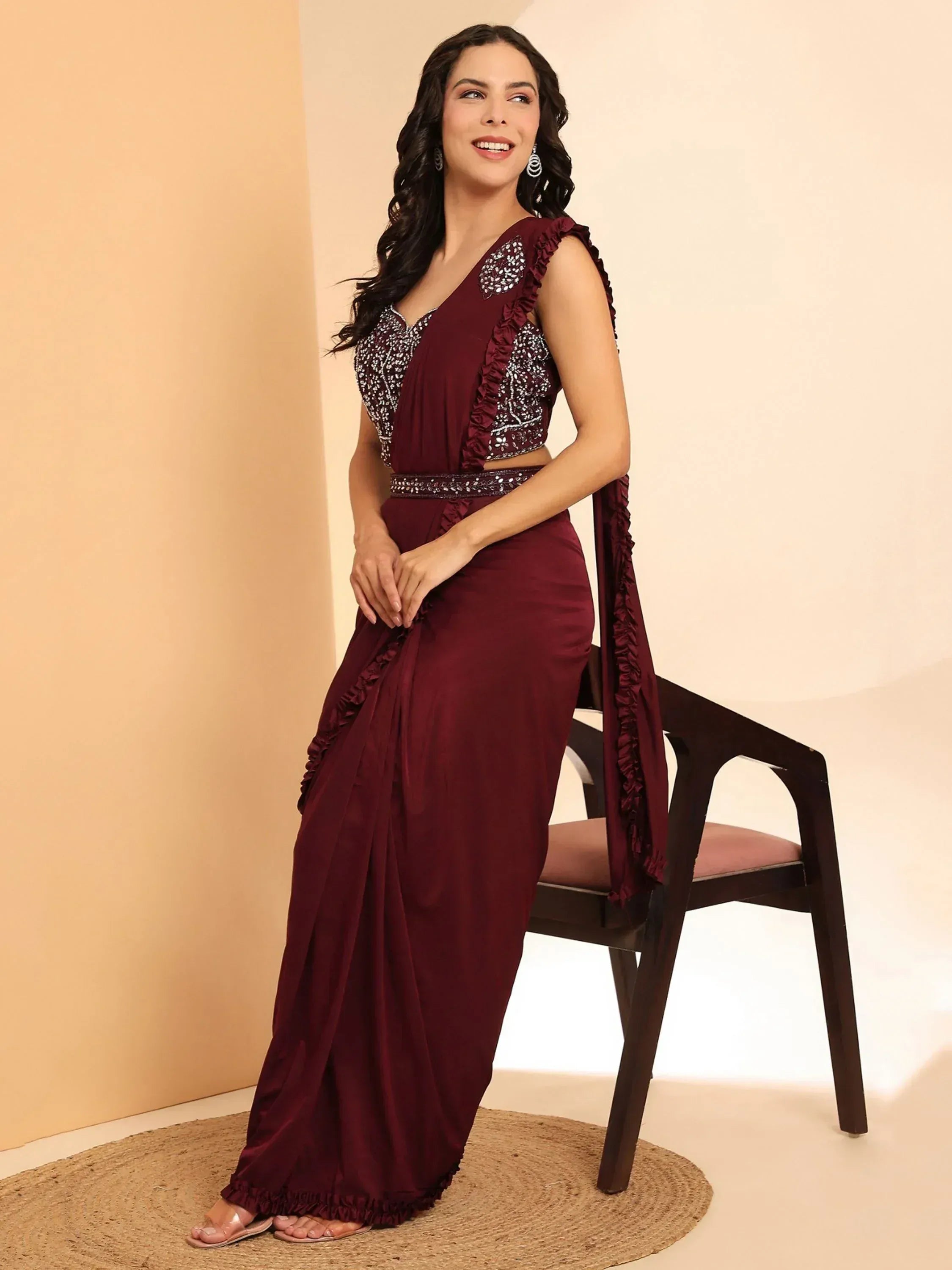 Maroon ethnic gown with ruffles and embellished top, perfect for Indian festive occasions