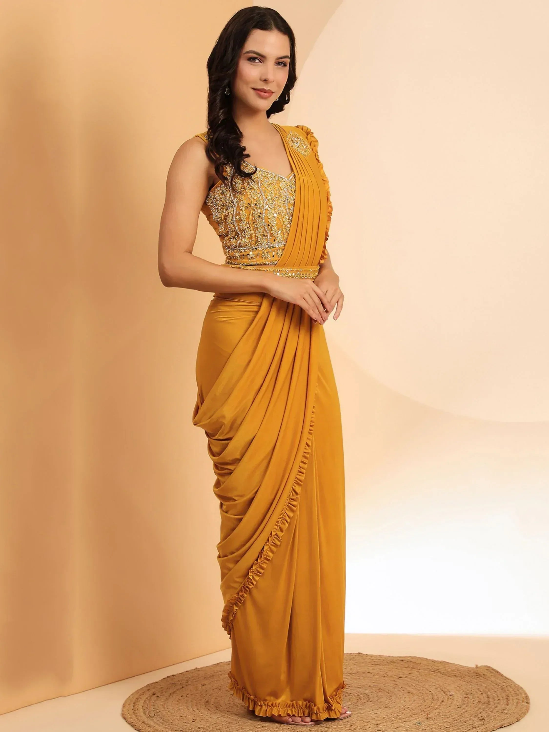 Mustard yellow designer saree with embroidered blouse and ruffled drapes, ethnic Indian wear