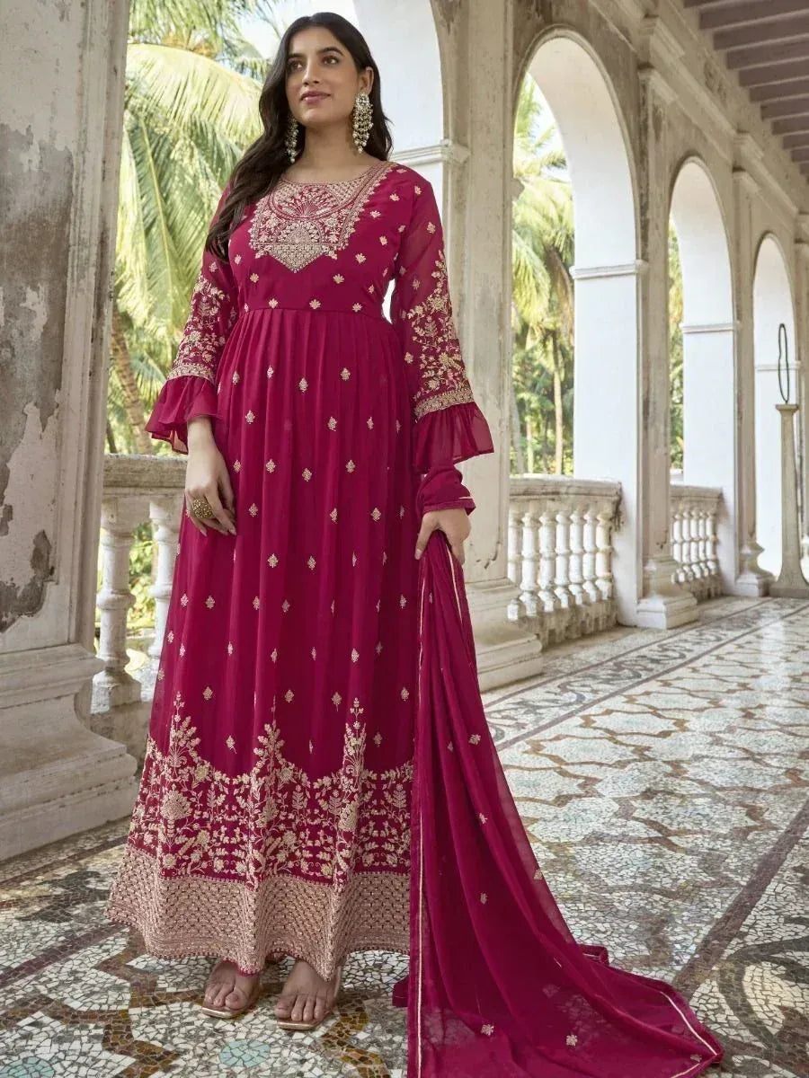Elegant maroon ethnic gown with gold embroidery, perfect for Indian occasions and festive wear.