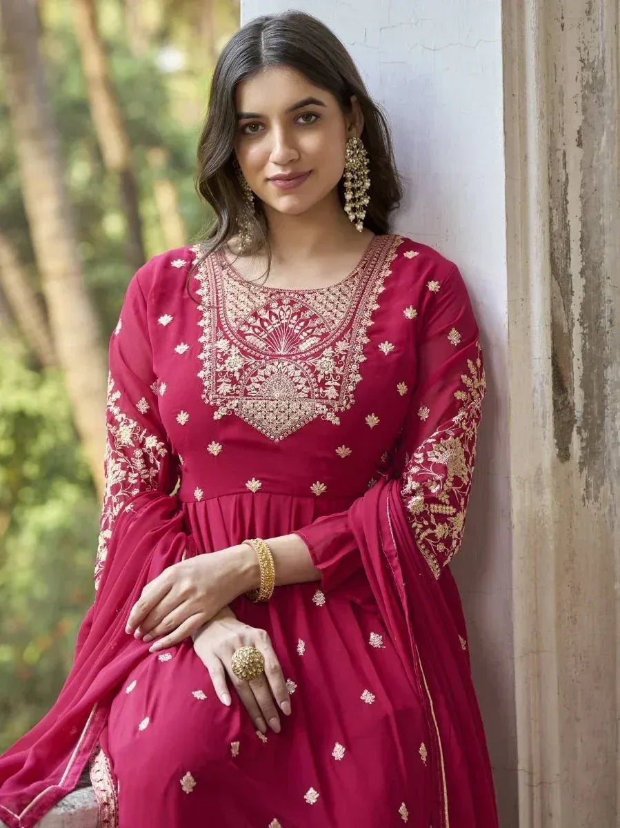 Maroon ethnic gown with gold embroidery, perfect for Indian occasions and festive wear.