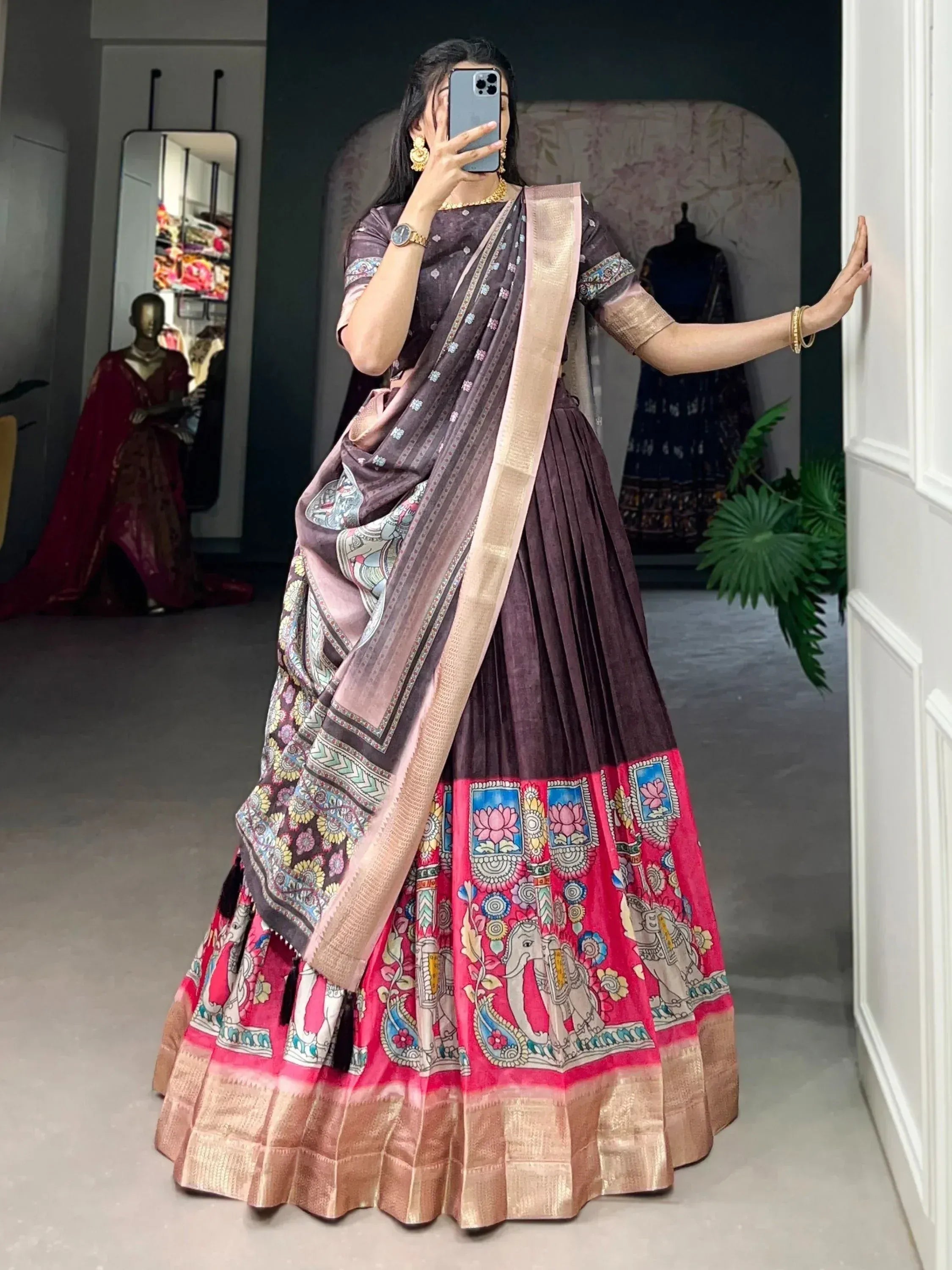 Woman in purple and pink printed lehenga choli with elephant motifs, ethnic Indian wear