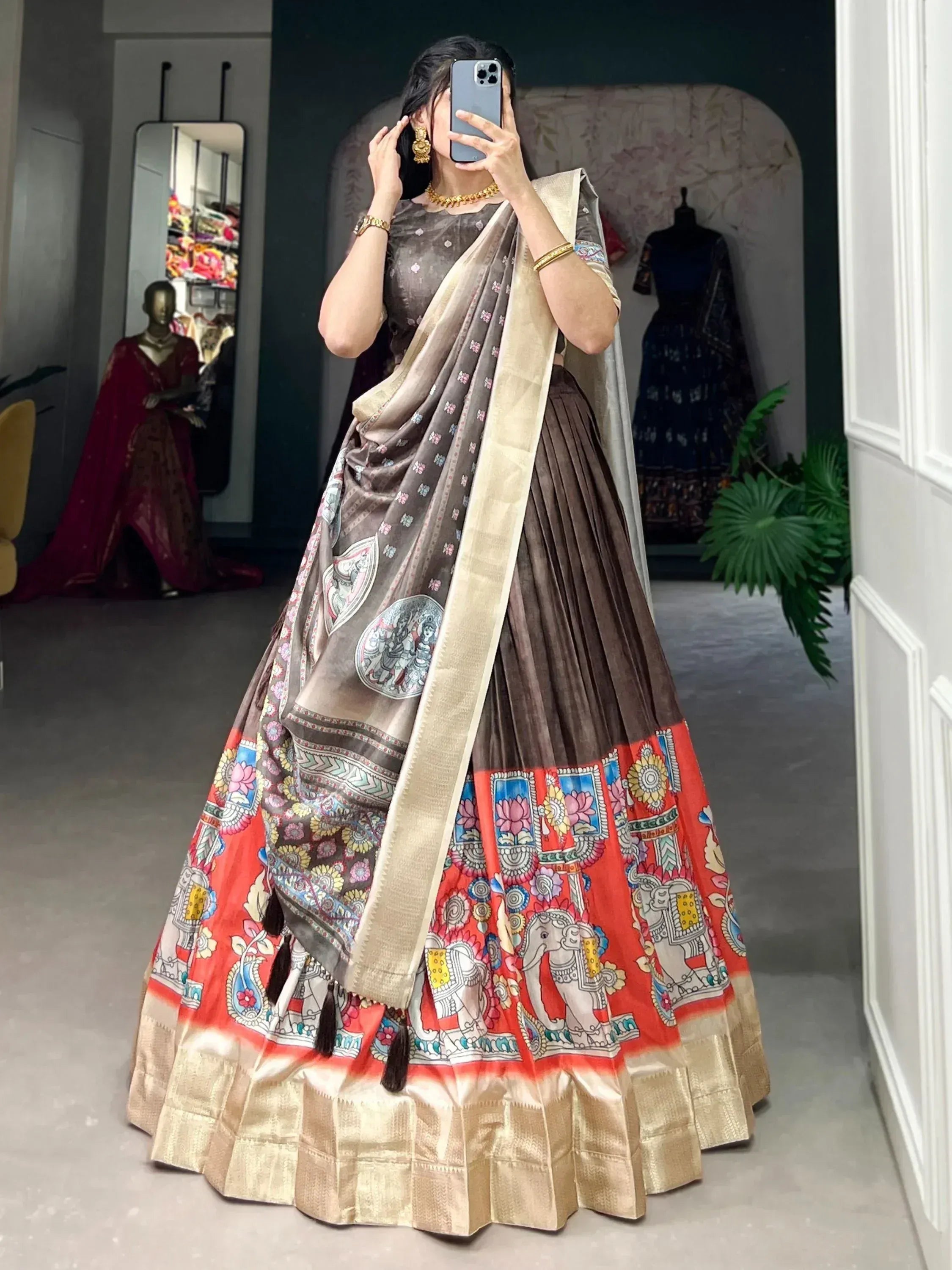 Brown and red printed lehenga choli with elephant motifs, gold border, and matching dupatta for Indian ethnic wear