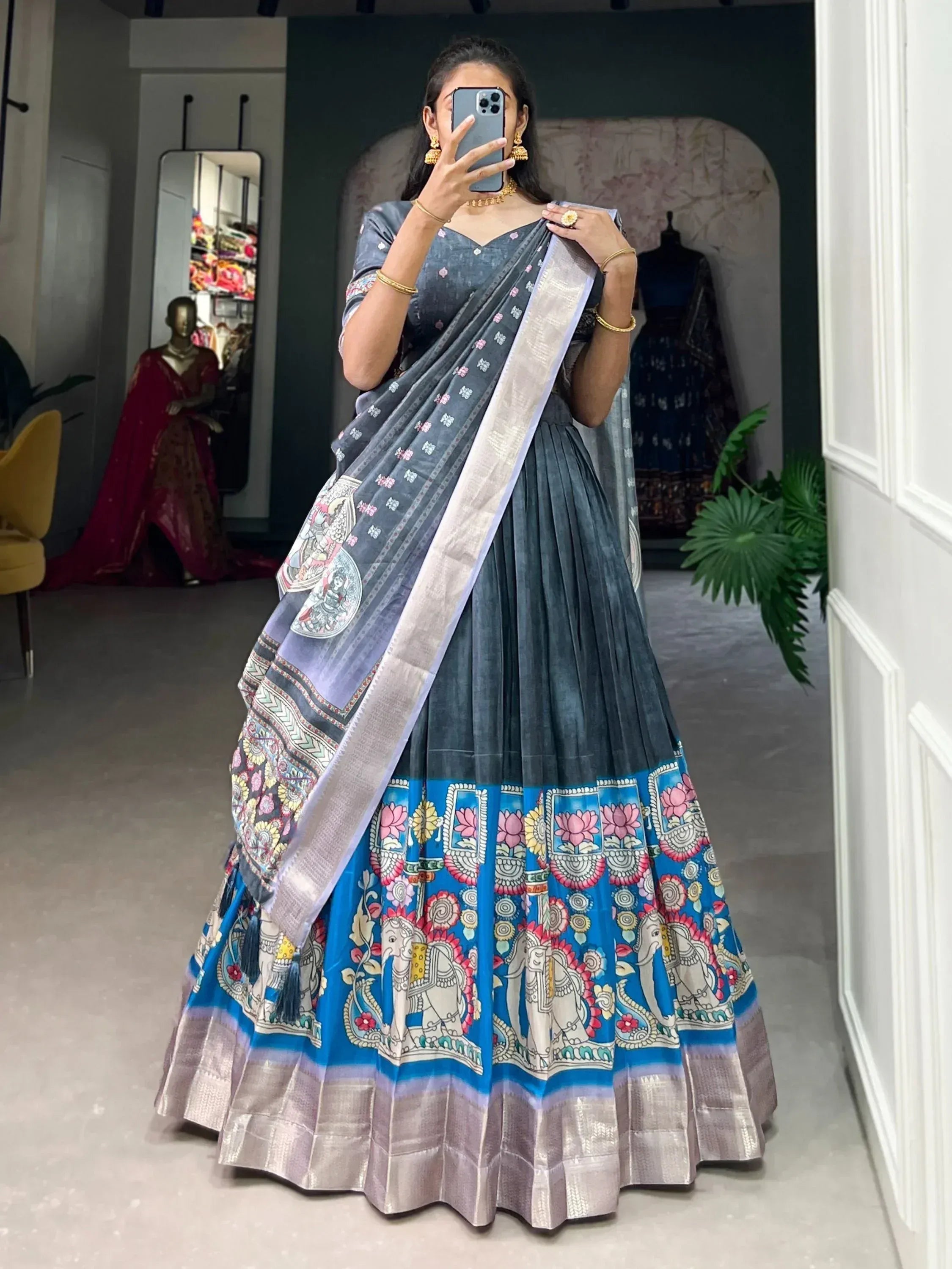 Woman in blue printed lehenga choli with elephant motifs, ethnic Indian wear for festive occasions
