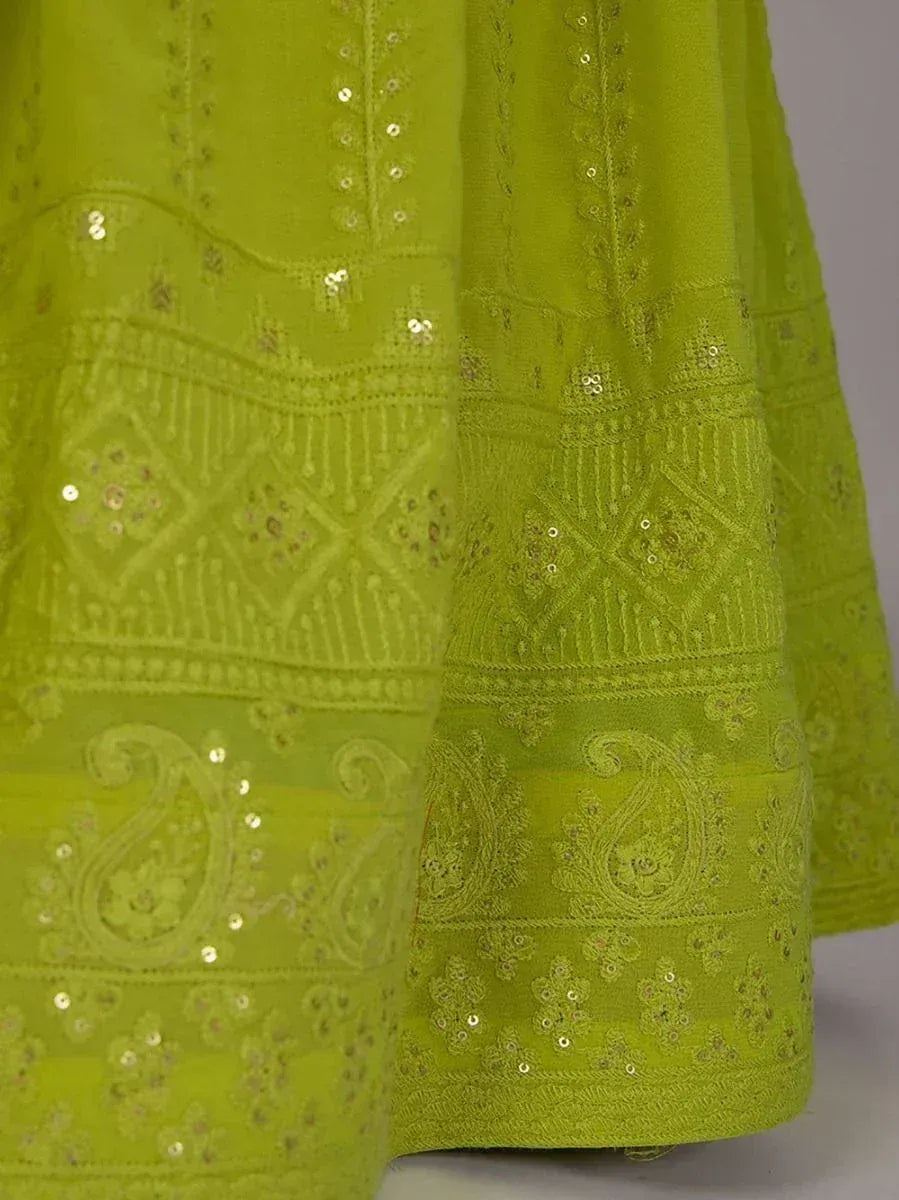 Lime green ethnic gown with intricate embroidery and sequin detailing, perfect for festive occasions.