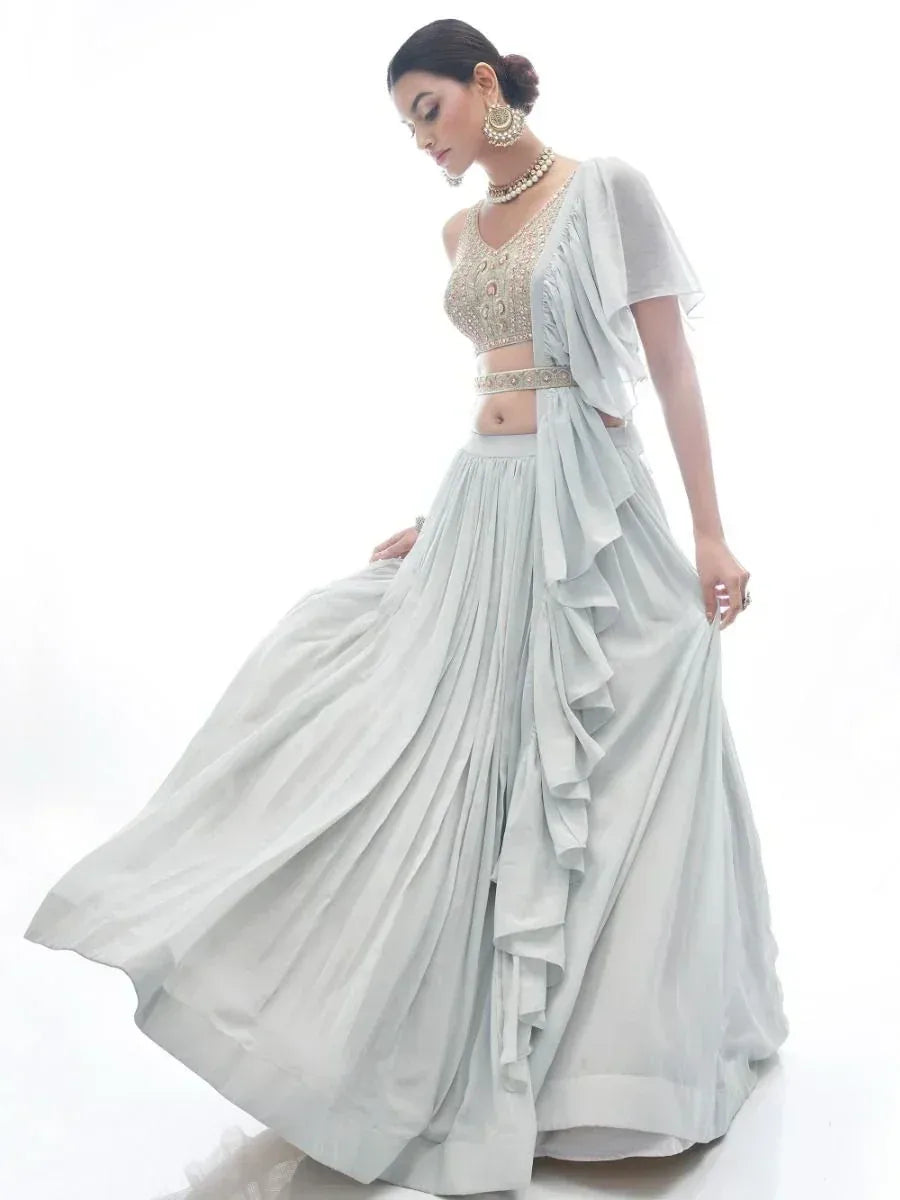 Elegant light blue lehenga choli with ruffled skirt and embroidered blouse, perfect for Indian ethnic occasions.