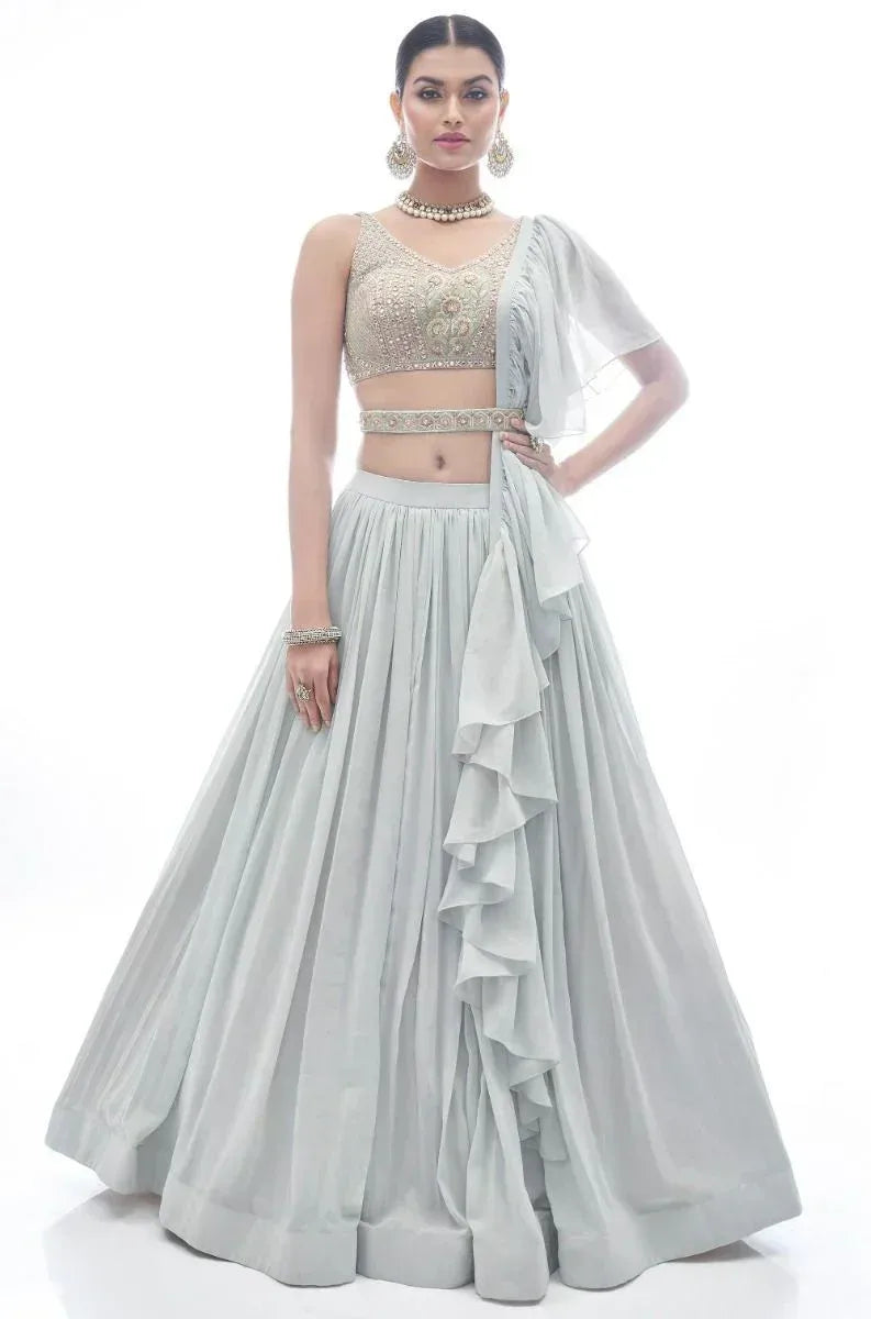 Elegant light blue lehenga choli with embroidered blouse and ruffled dupatta, perfect for Indian ethnic occasions