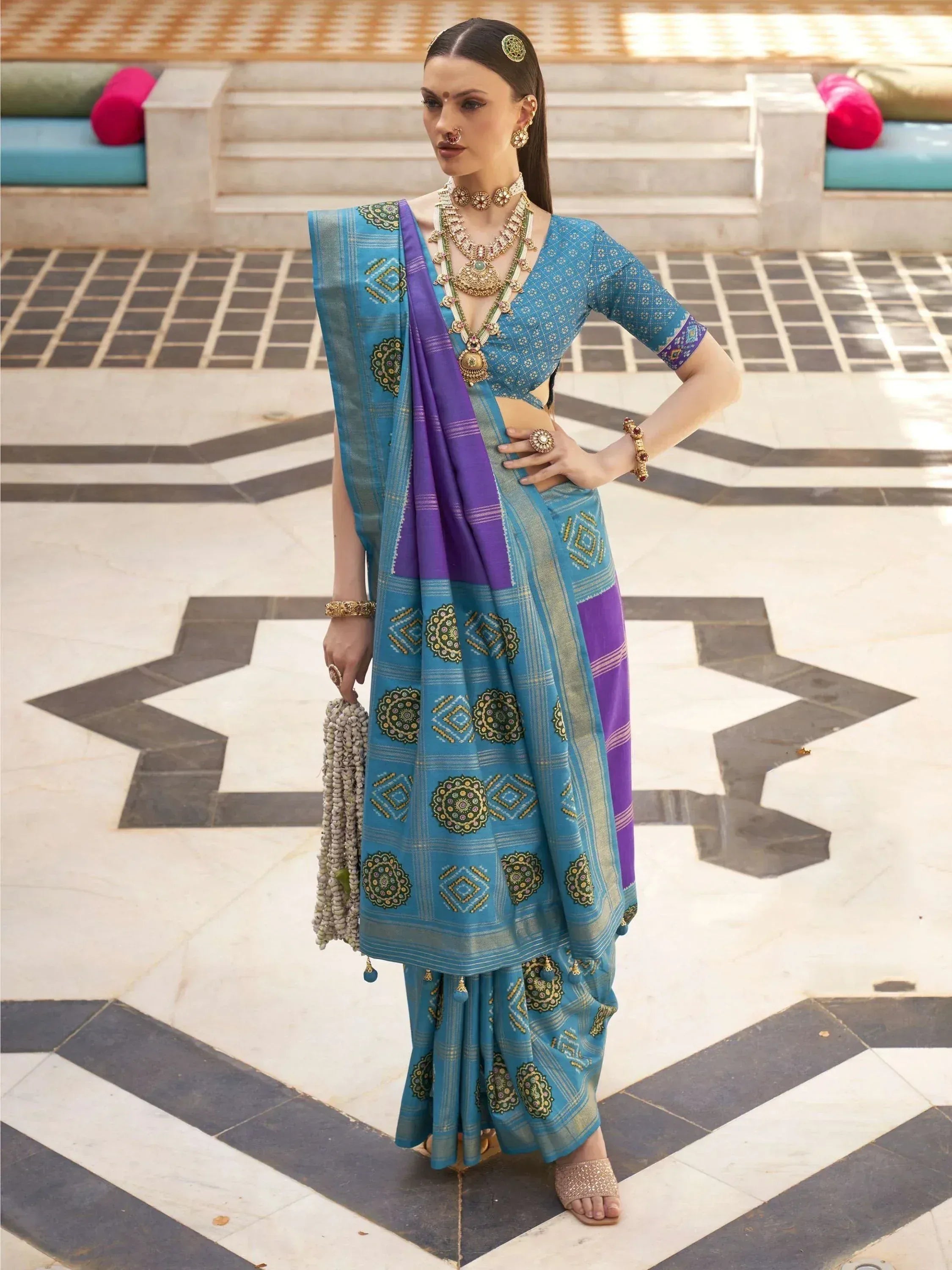 Blue and purple embroidered lehenga choli with traditional Indian jewelry, perfect for ethnic occasions.