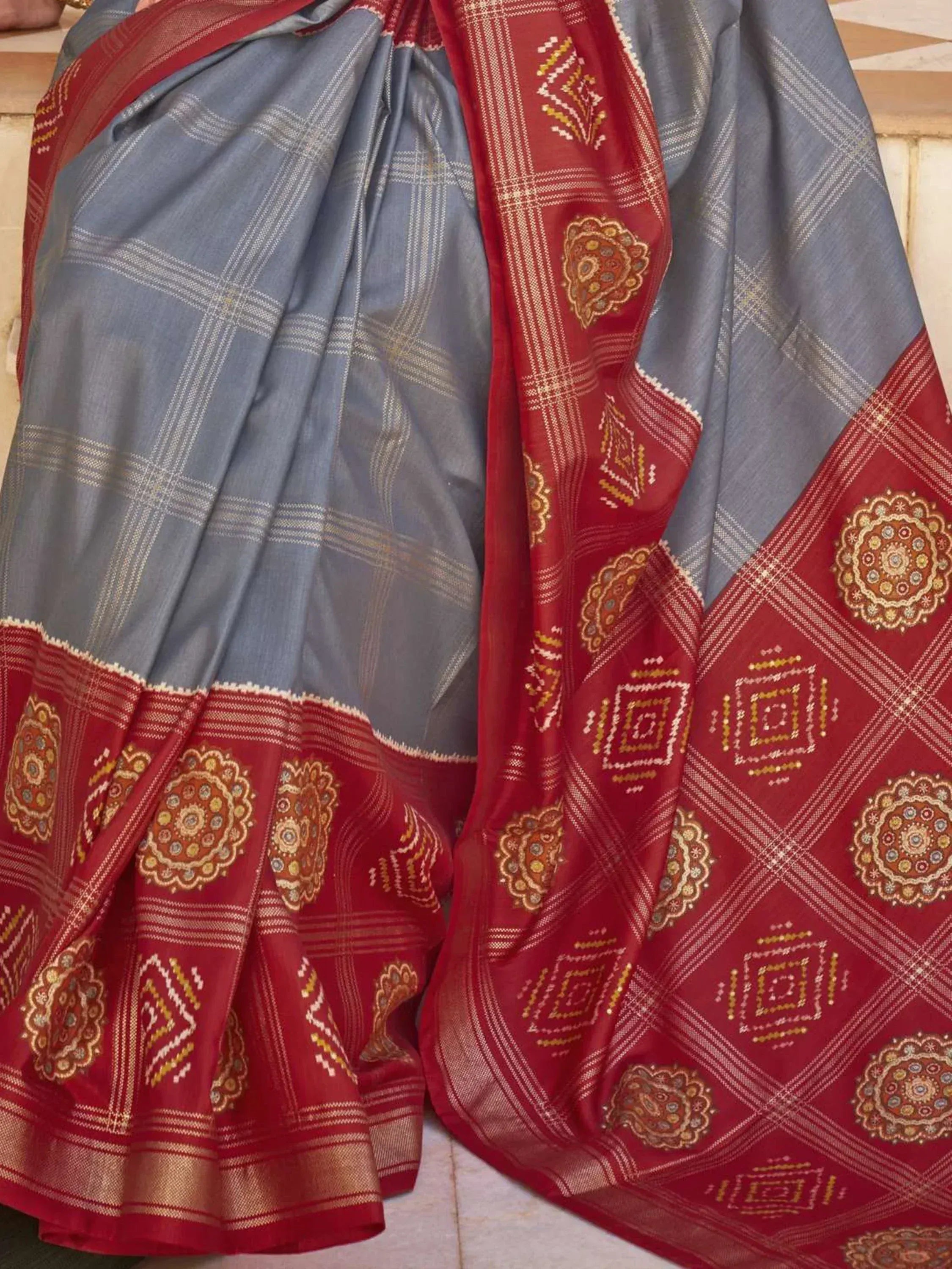 Blue and red ethnic saree with intricate geometric and floral patterns, perfect for traditional Indian wear.