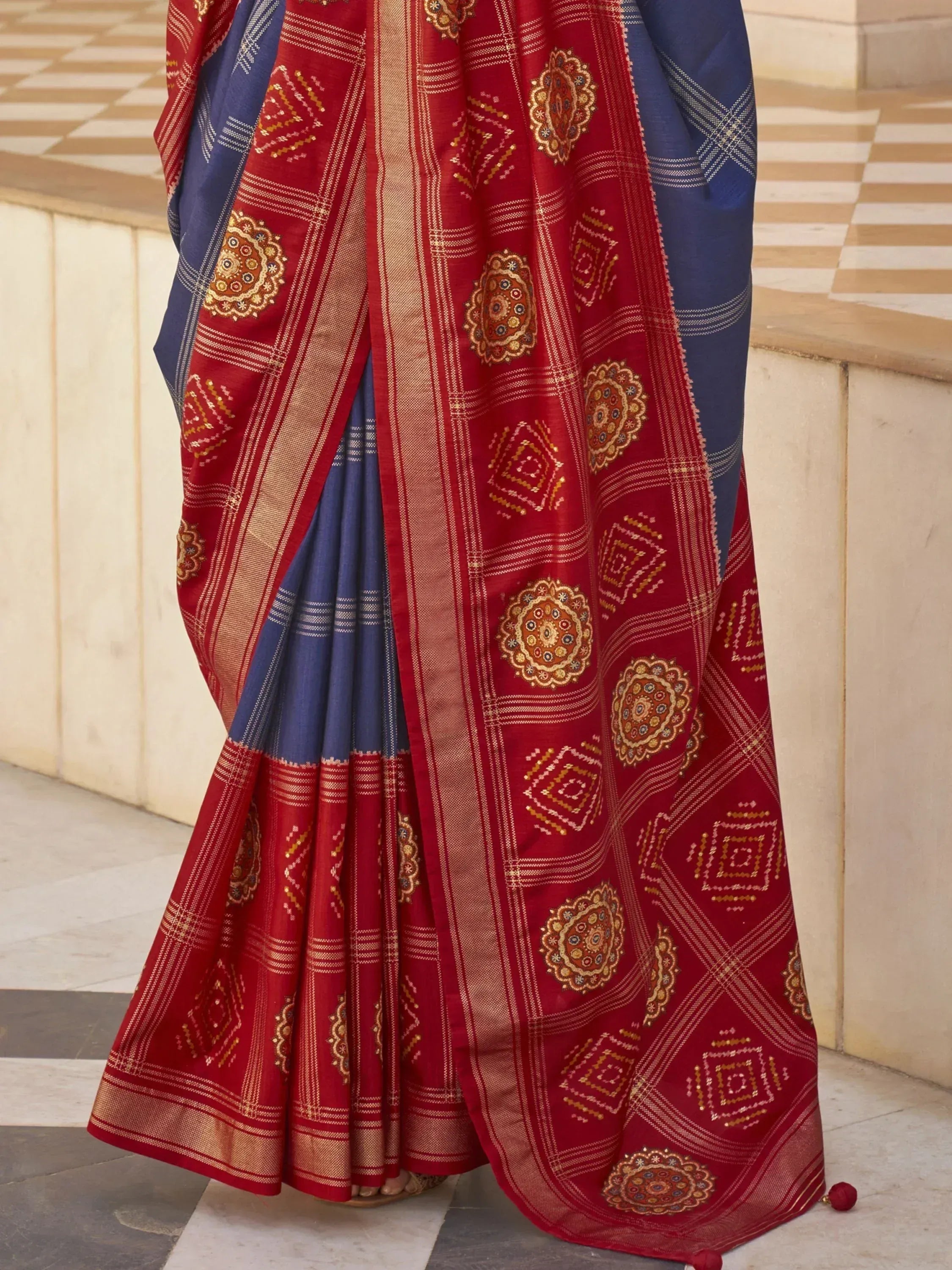 Red and blue ethnic saree with intricate gold patterns, perfect for Indian festive occasions