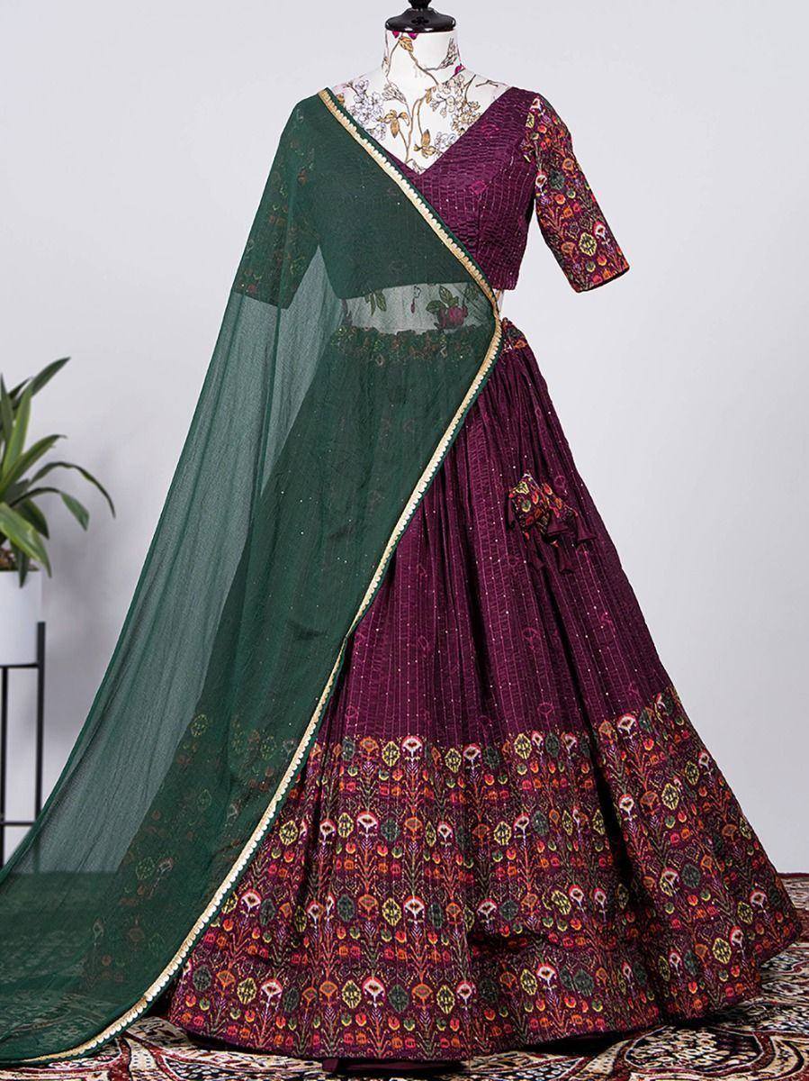 Elegant maroon and green embroidered lehenga choli with floral dupatta, perfect for Indian ethnic occasions.