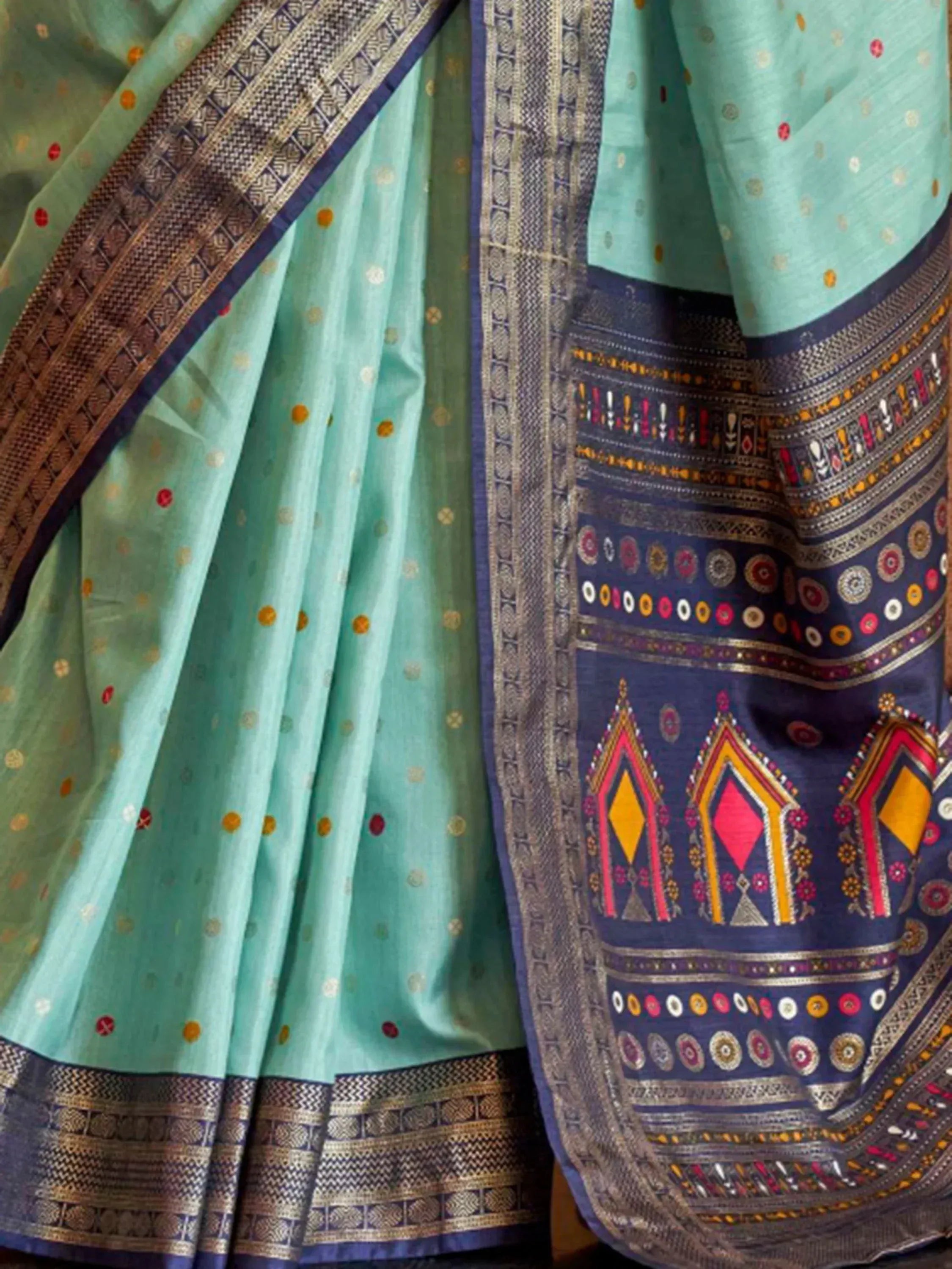 Mint green saree with colorful geometric border and traditional Indian ethnic print