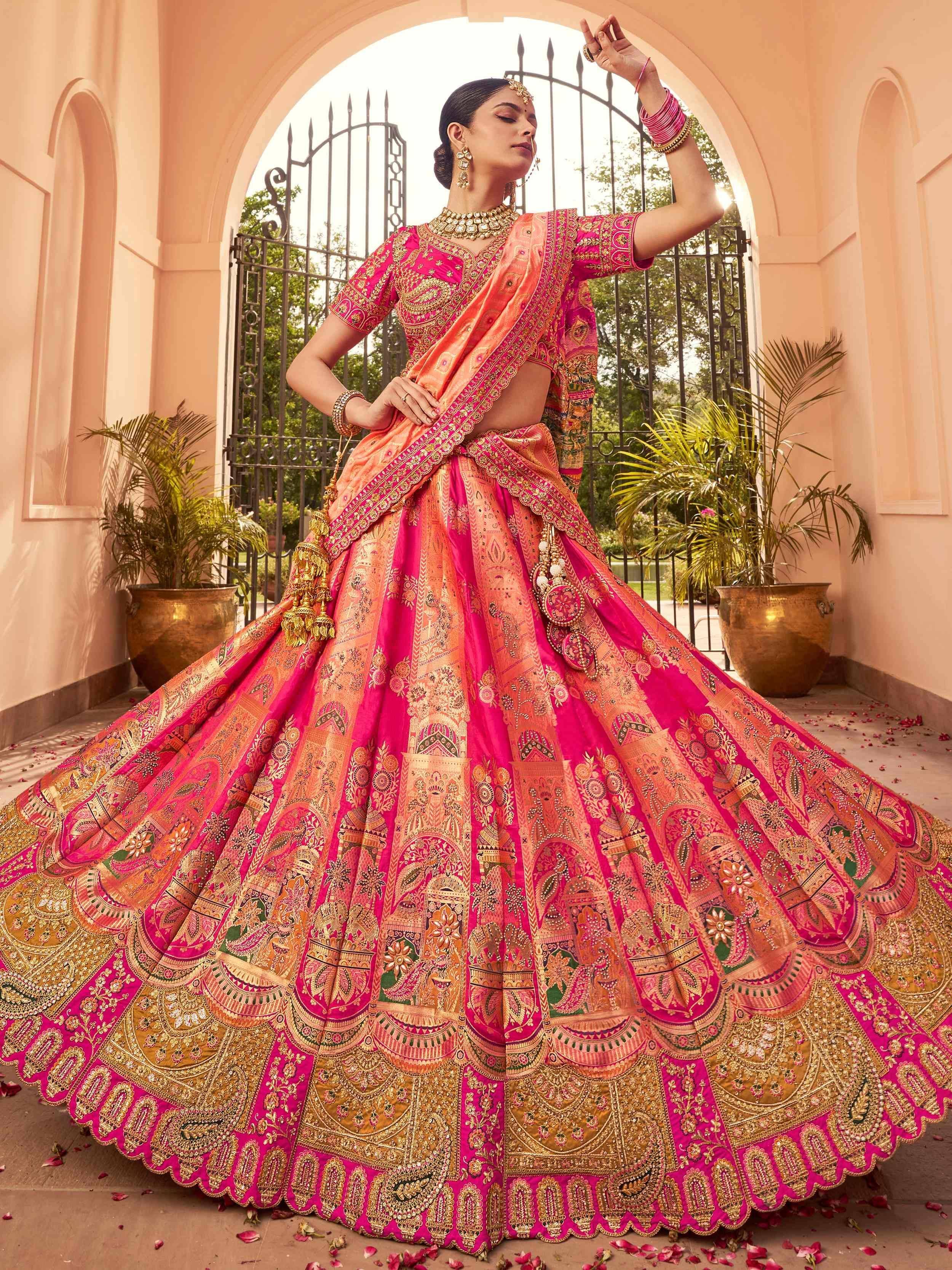 Pink and gold embroidered lehenga choli with intricate designs, perfect for Indian weddings and festive occasions.