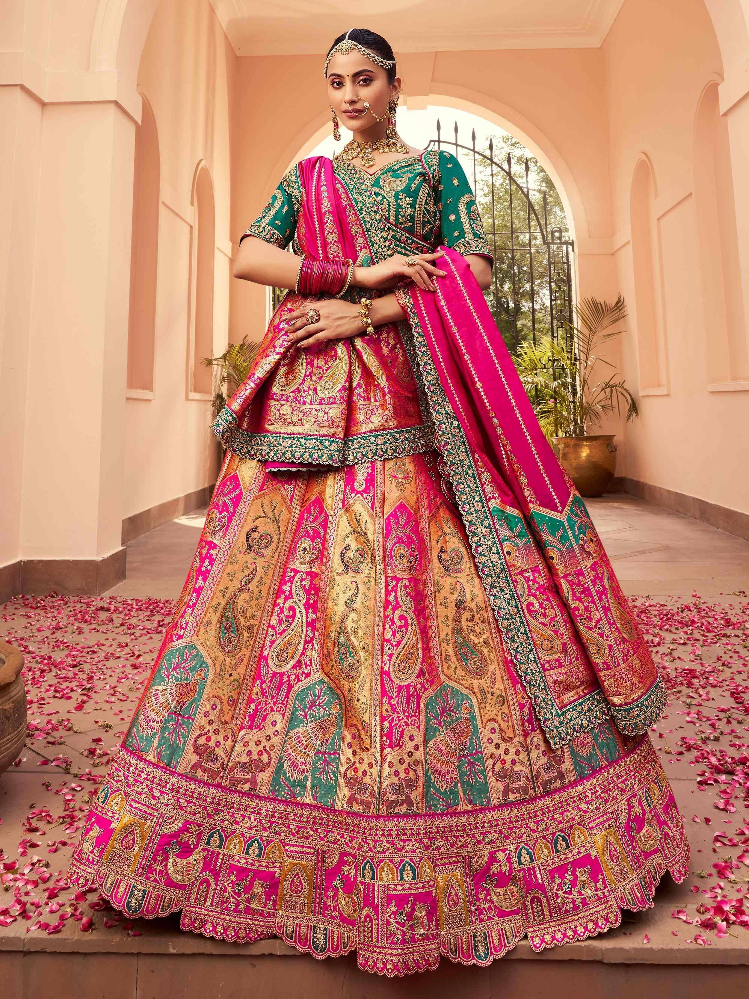 Pink and green designer lehenga choli with intricate embroidery, perfect for Indian weddings and festive occasions.