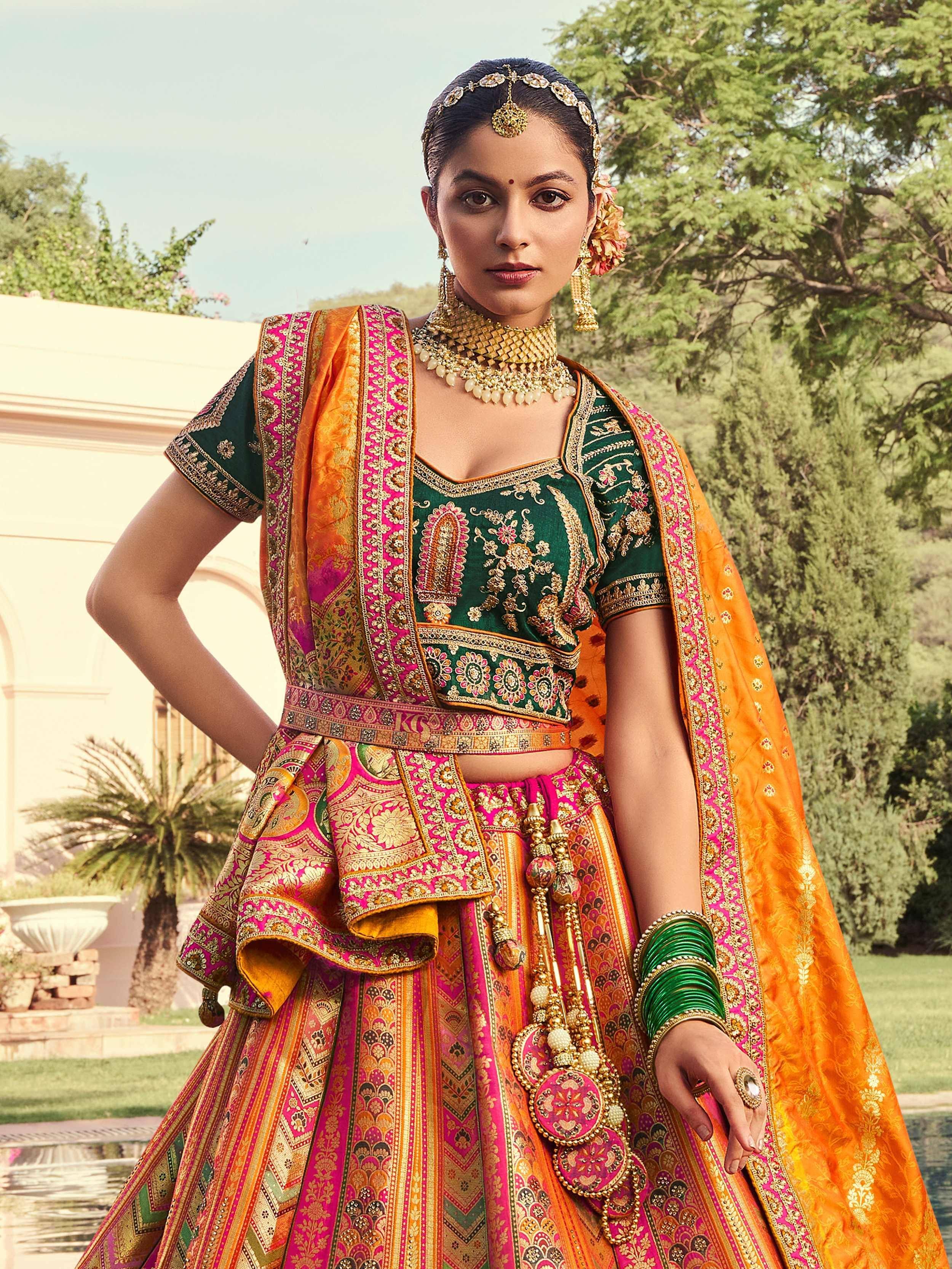 Designer lehenga choli with intricate embroidery, vibrant pink and green colors, perfect for Indian weddings and festive occasions.