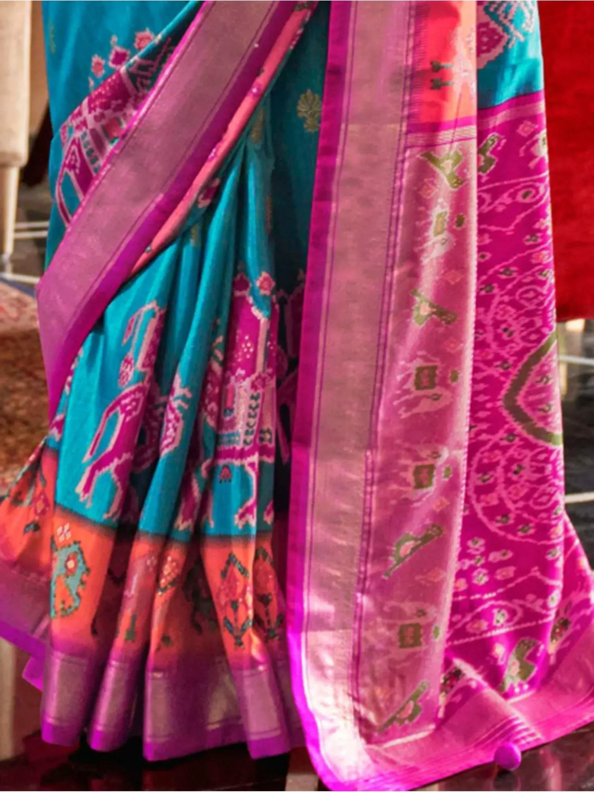 Teal and magenta ethnic saree with intricate printed patterns and woven border, perfect for Indian occasions