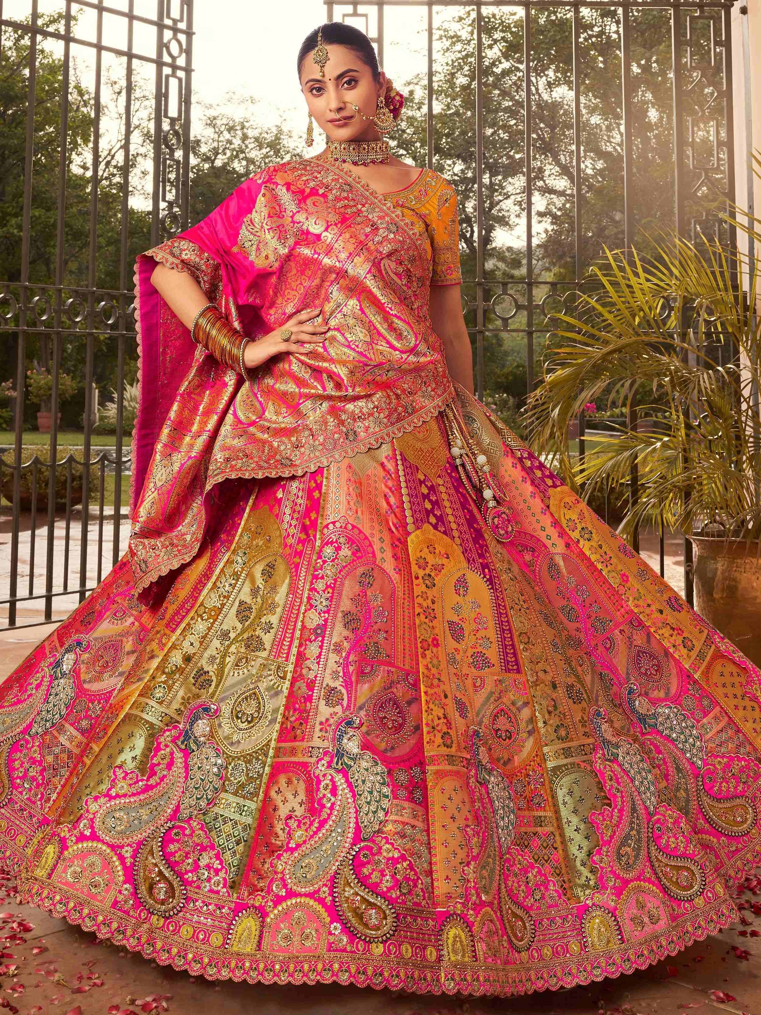 Vibrant pink and gold embroidered lehenga choli with peacock motifs, perfect for Indian weddings and festive occasions.