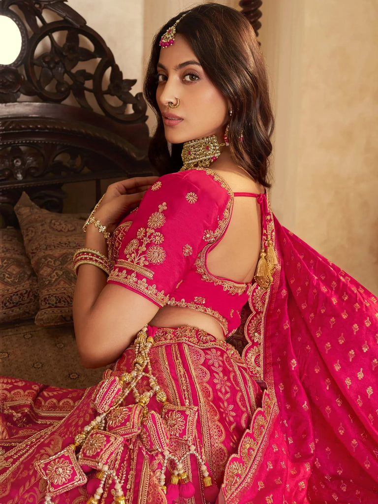 Pink designer lehenga choli with gold embroidery, perfect for Indian weddings and festive occasions.