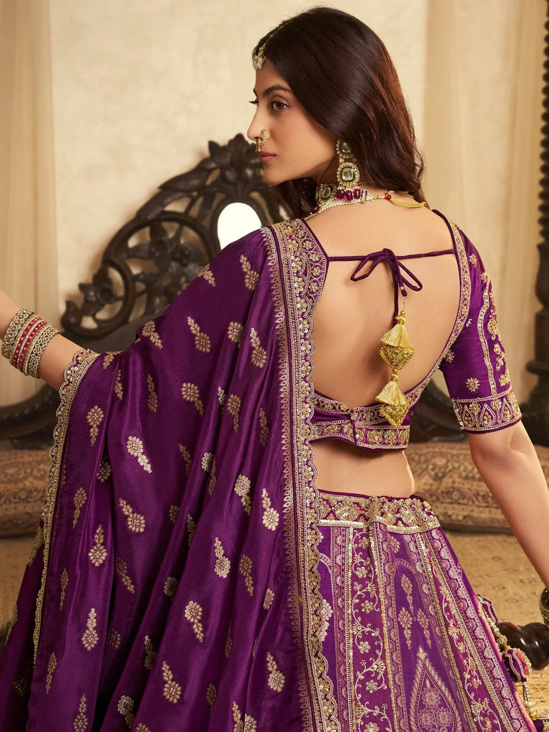 Purple designer lehenga choli with gold embroidery and back tie detail, perfect for Indian ethnic wear.