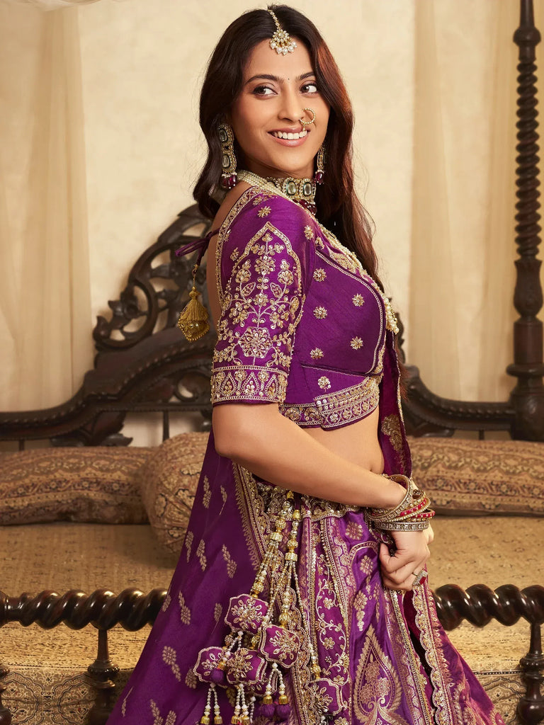Purple embroidered lehenga choli with gold detailing, perfect for Indian weddings and festive occasions.