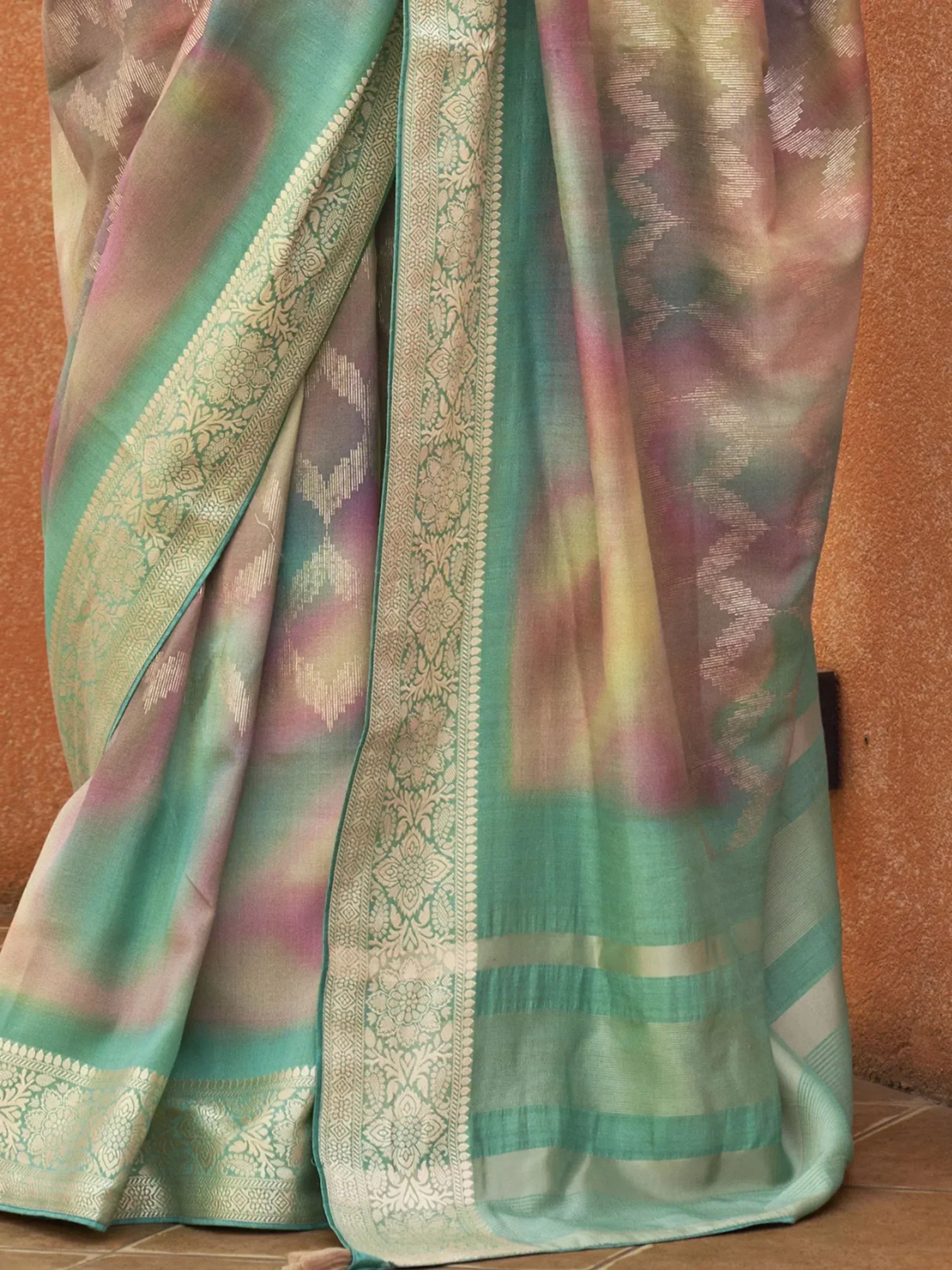 Pastel green and pink ethnic saree with gold zari border, perfect for Indian occasions
