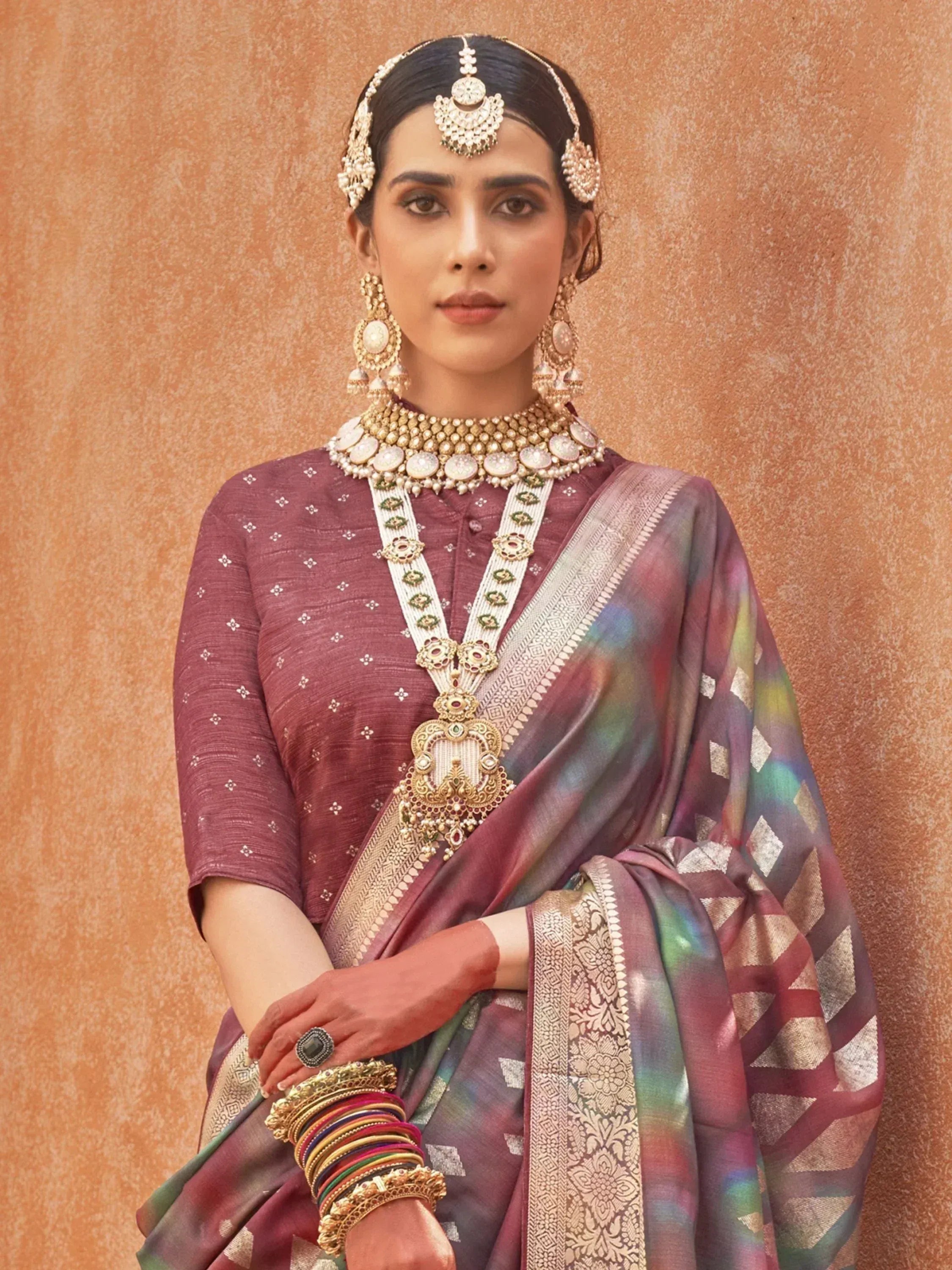 Elegant Indian woman in maroon saree with gold jewelry, traditional ethnic wear for weddings and festivals