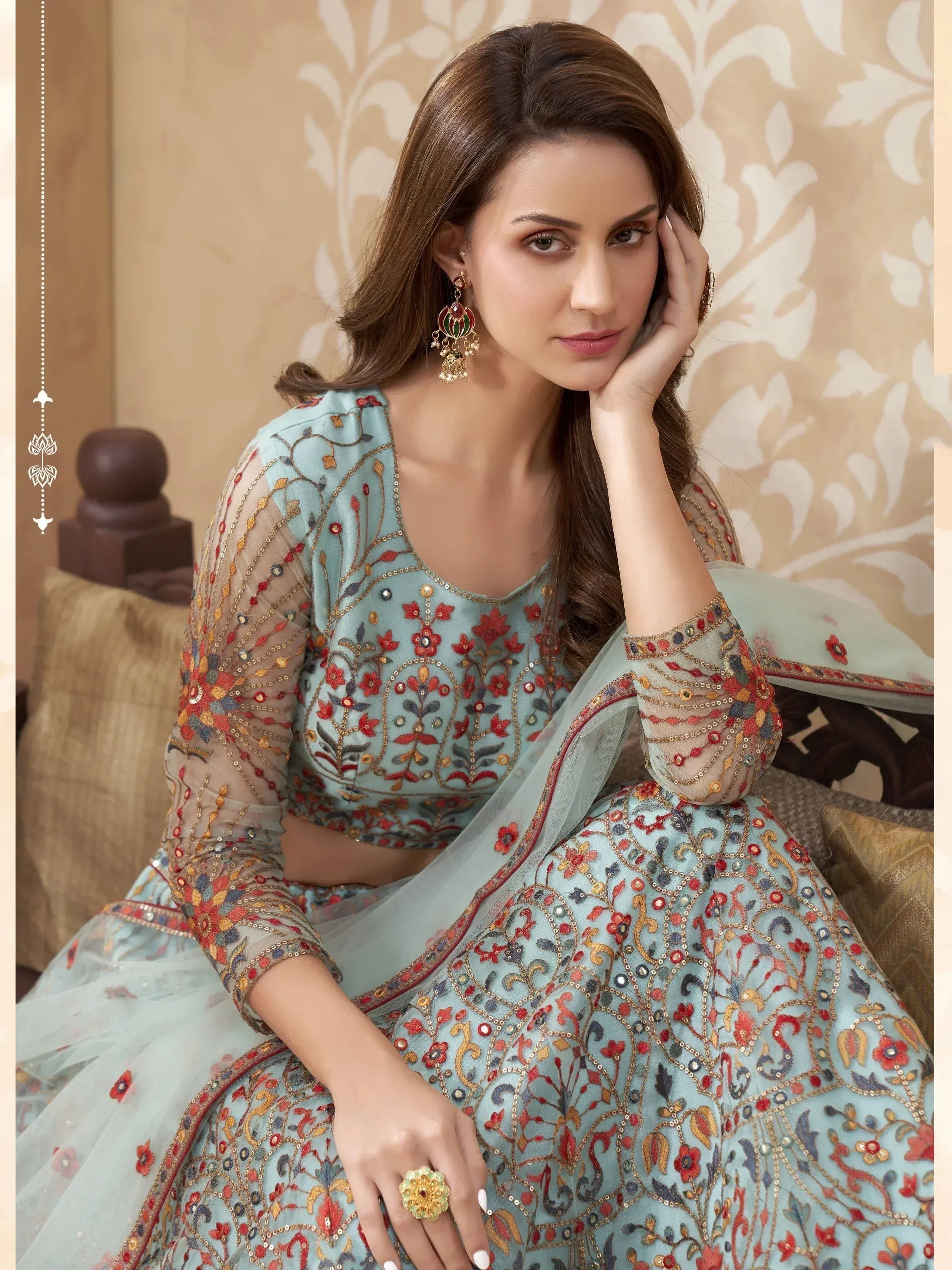 Elegant light blue embroidered lehenga choli with floral motifs and sheer sleeves, perfect for Indian ethnic wear.