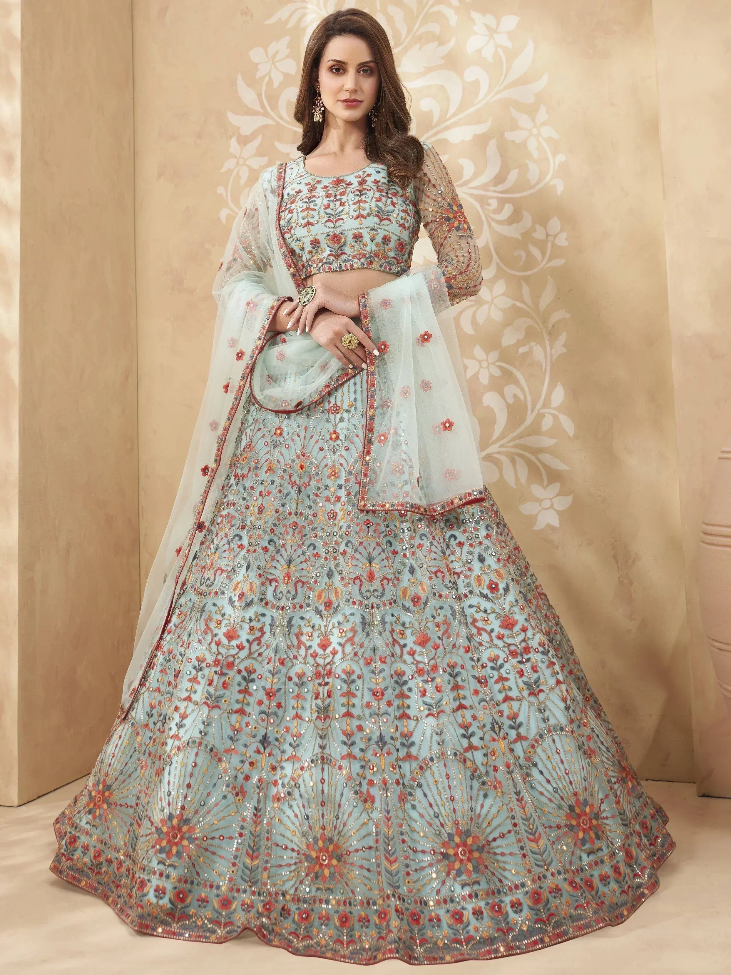 Light blue embroidered lehenga choli with floral motifs and sheer dupatta, perfect for Indian weddings or festive occasions.