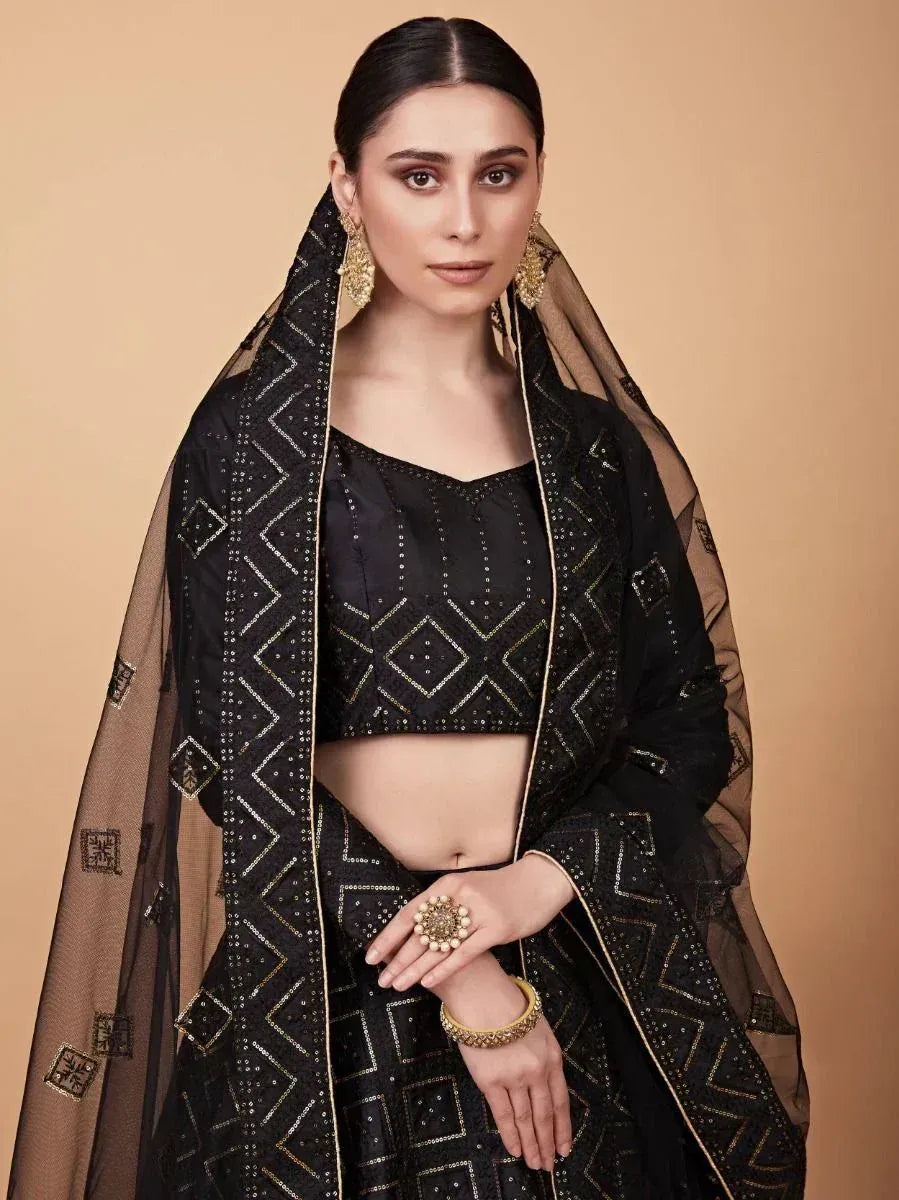 Black embroidered lehenga choli with gold detailing and sheer dupatta, perfect for Indian ethnic wear occasions.