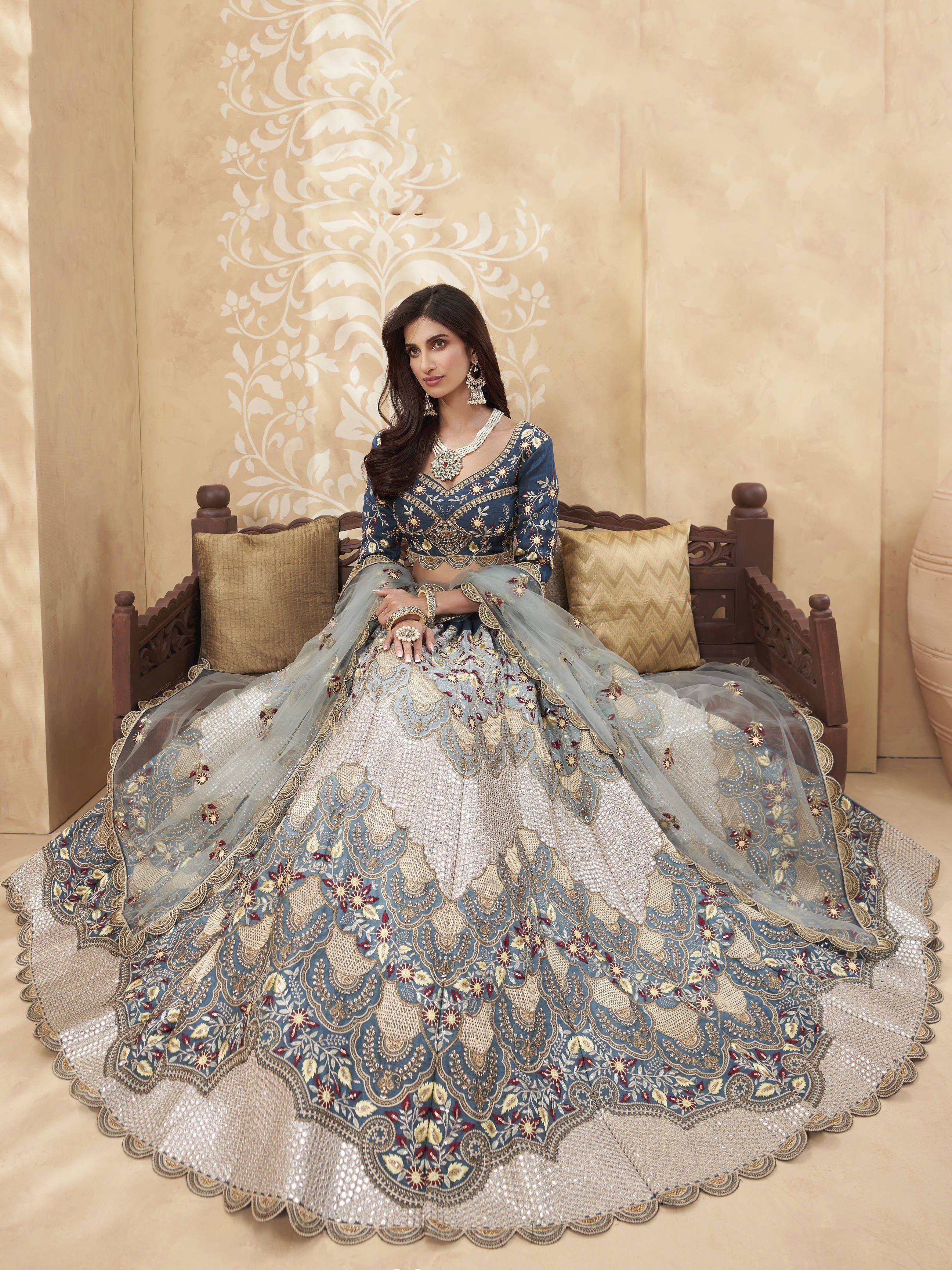 Elegant blue and gold embroidered lehenga choli with floral motifs, perfect for Indian weddings and festive occasions.