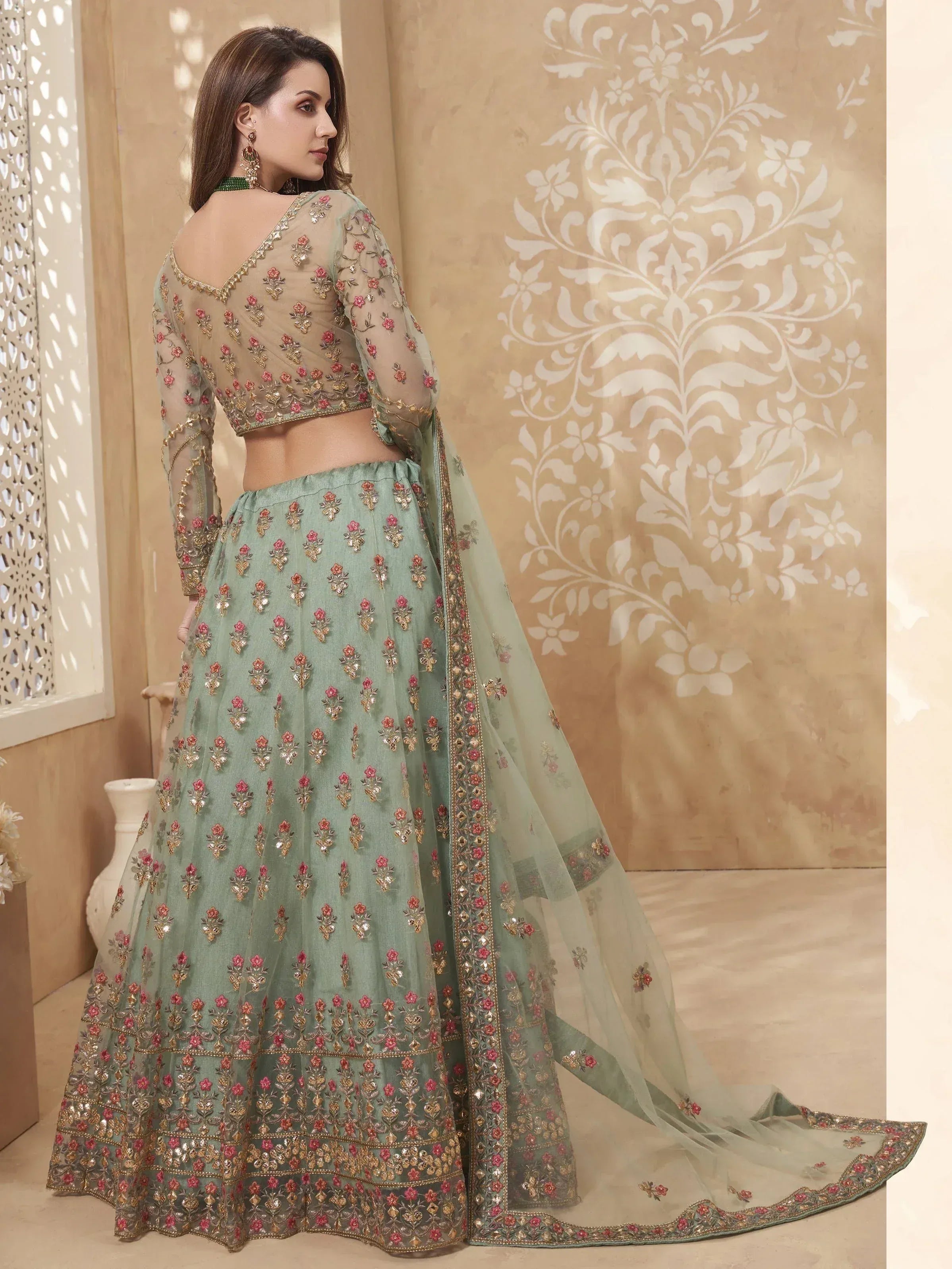 Mint green embroidered lehenga choli with floral motifs and sheer dupatta, perfect for Indian ethnic occasions.
