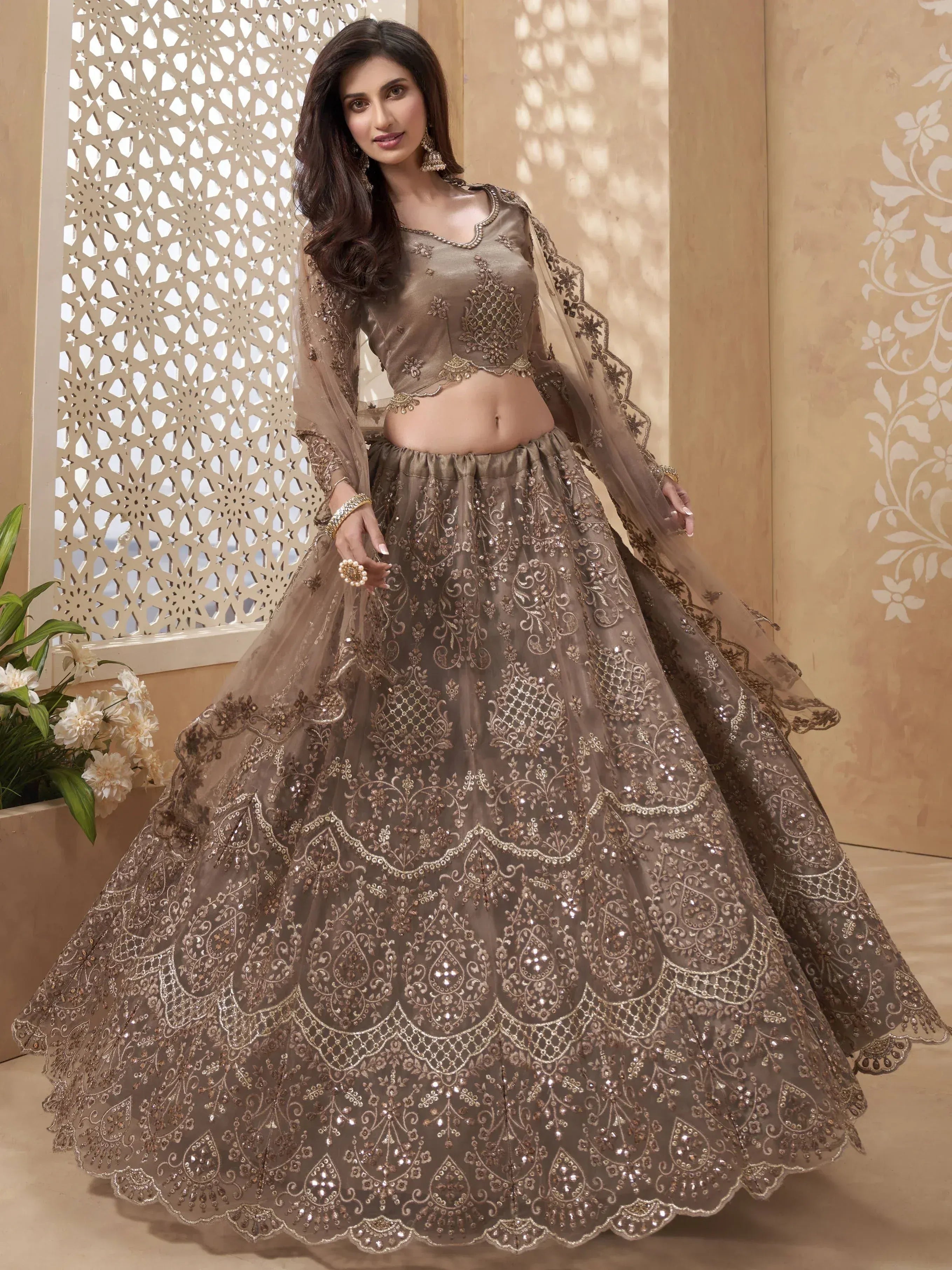 Elegant brown embroidered lehenga choli with sheer dupatta, perfect for Indian weddings and festive occasions.