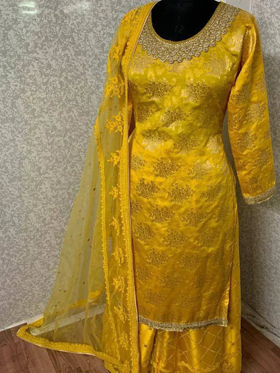 Yellow ethnic salwar kameez with gold embroidery and matching dupatta, ideal for festive occasions