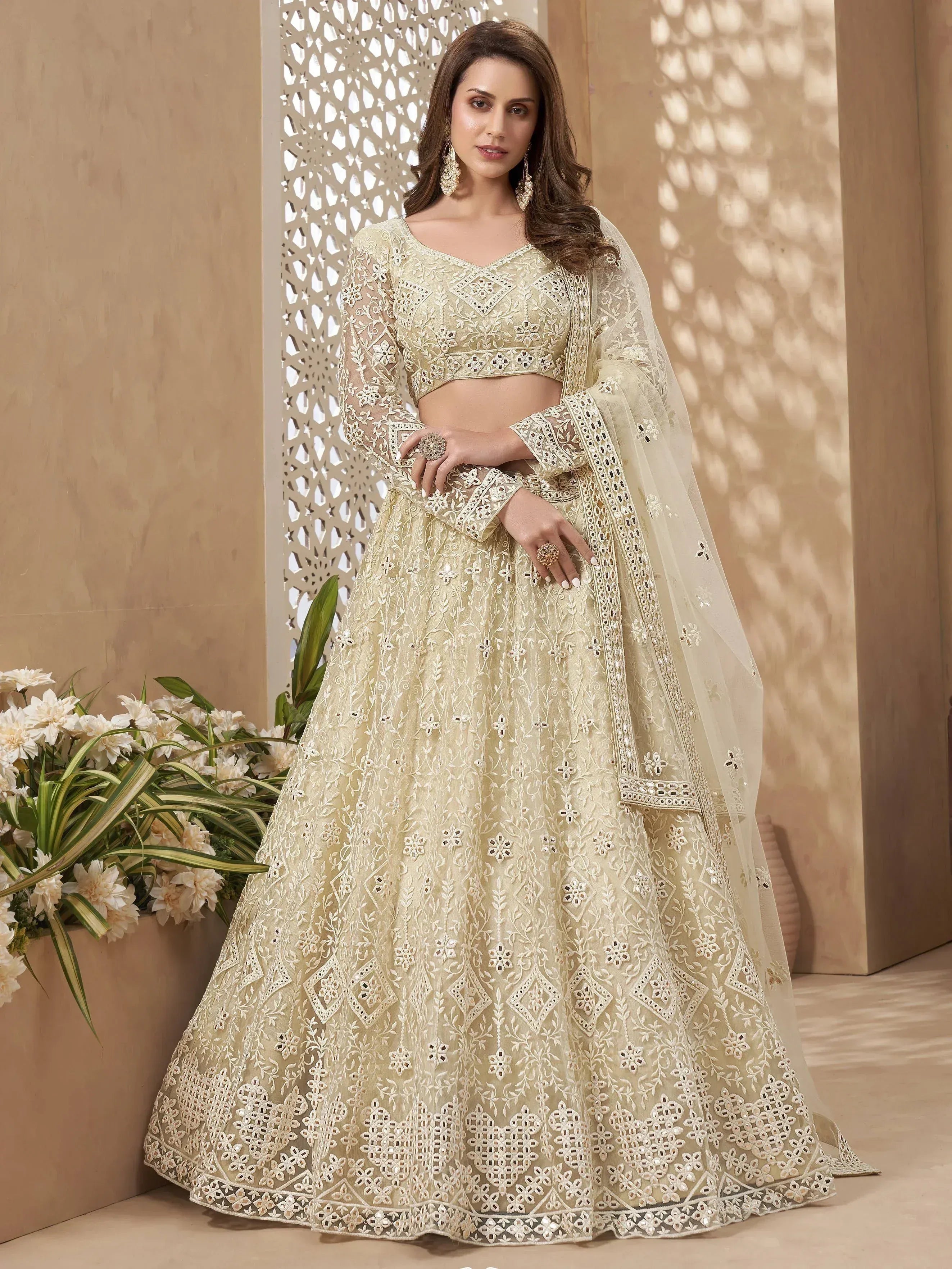 Elegant ivory embroidered lehenga choli with sheer dupatta, perfect for Indian weddings and festive occasions.