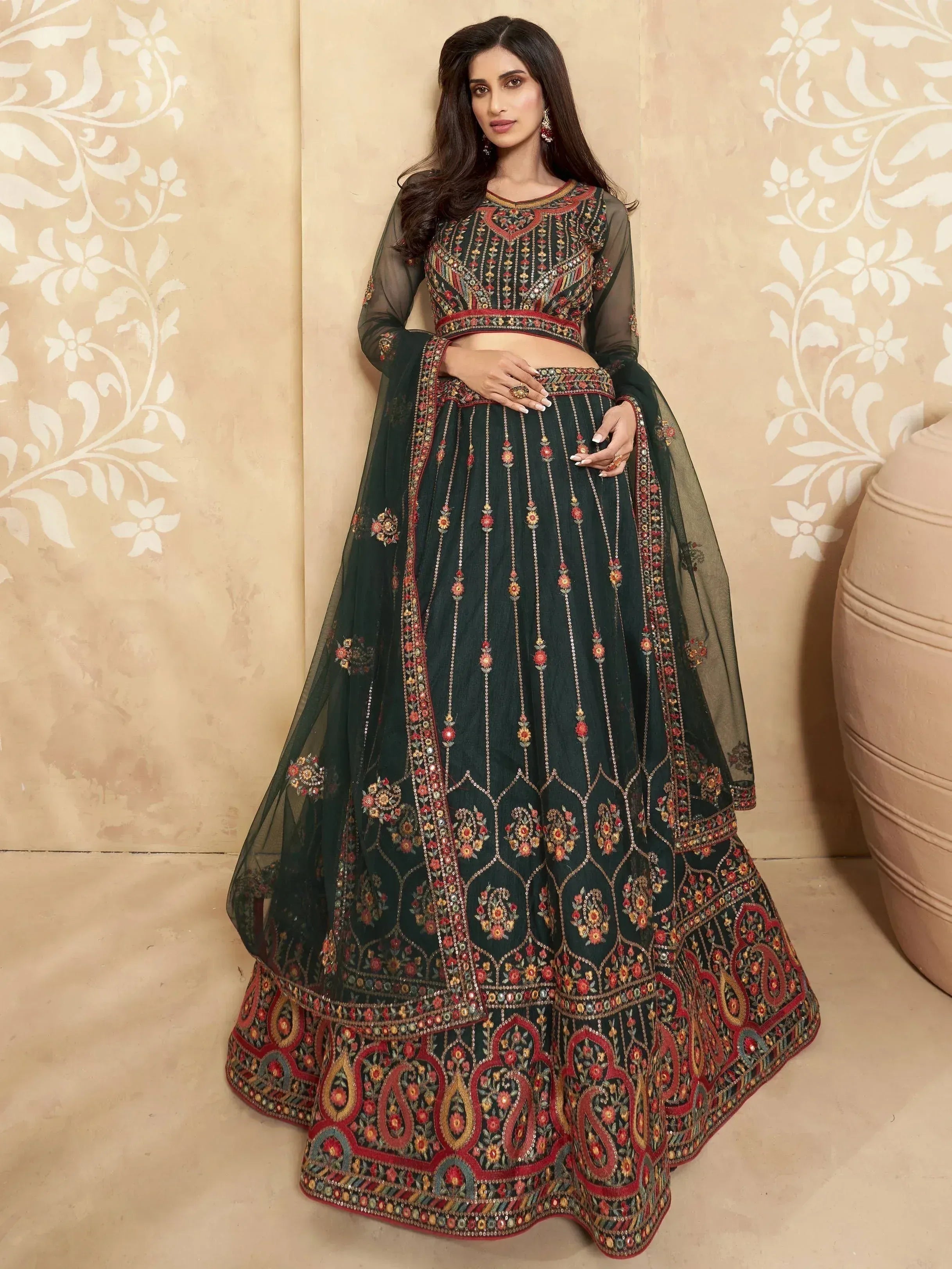 Dark green embroidered lehenga choli with sheer sleeves and floral motifs, perfect for Indian ethnic wear.