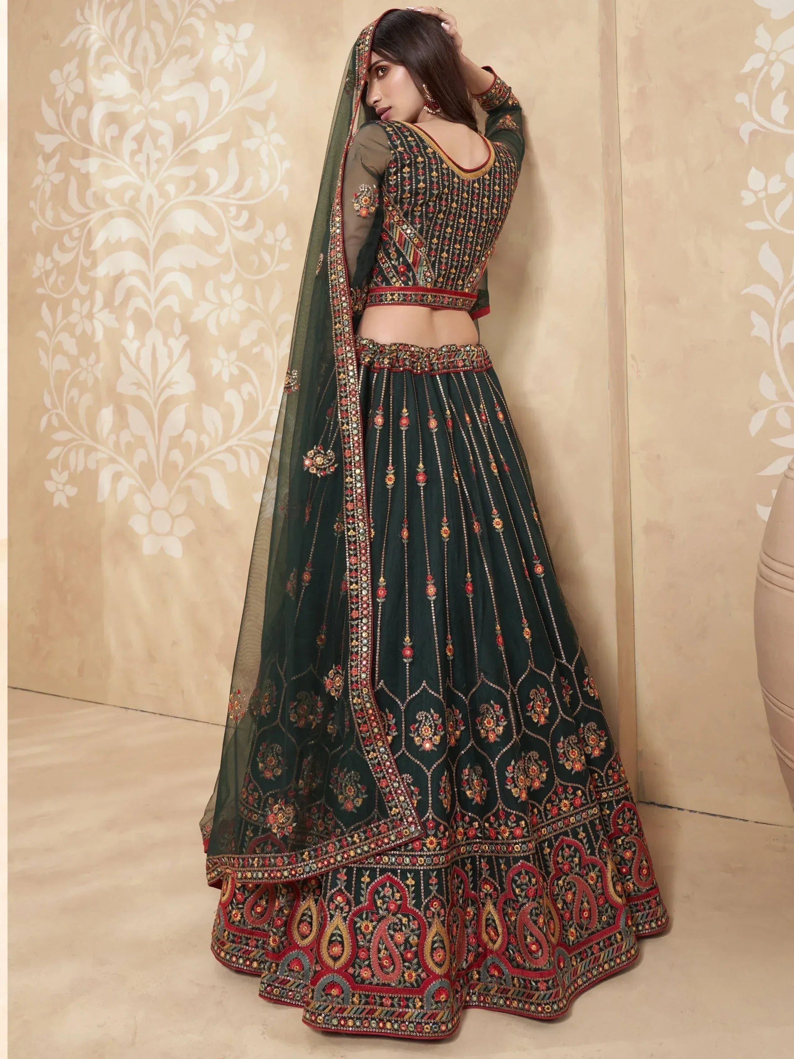 Dark green embroidered lehenga choli with floral motifs and sheer dupatta, perfect for Indian ethnic occasions.