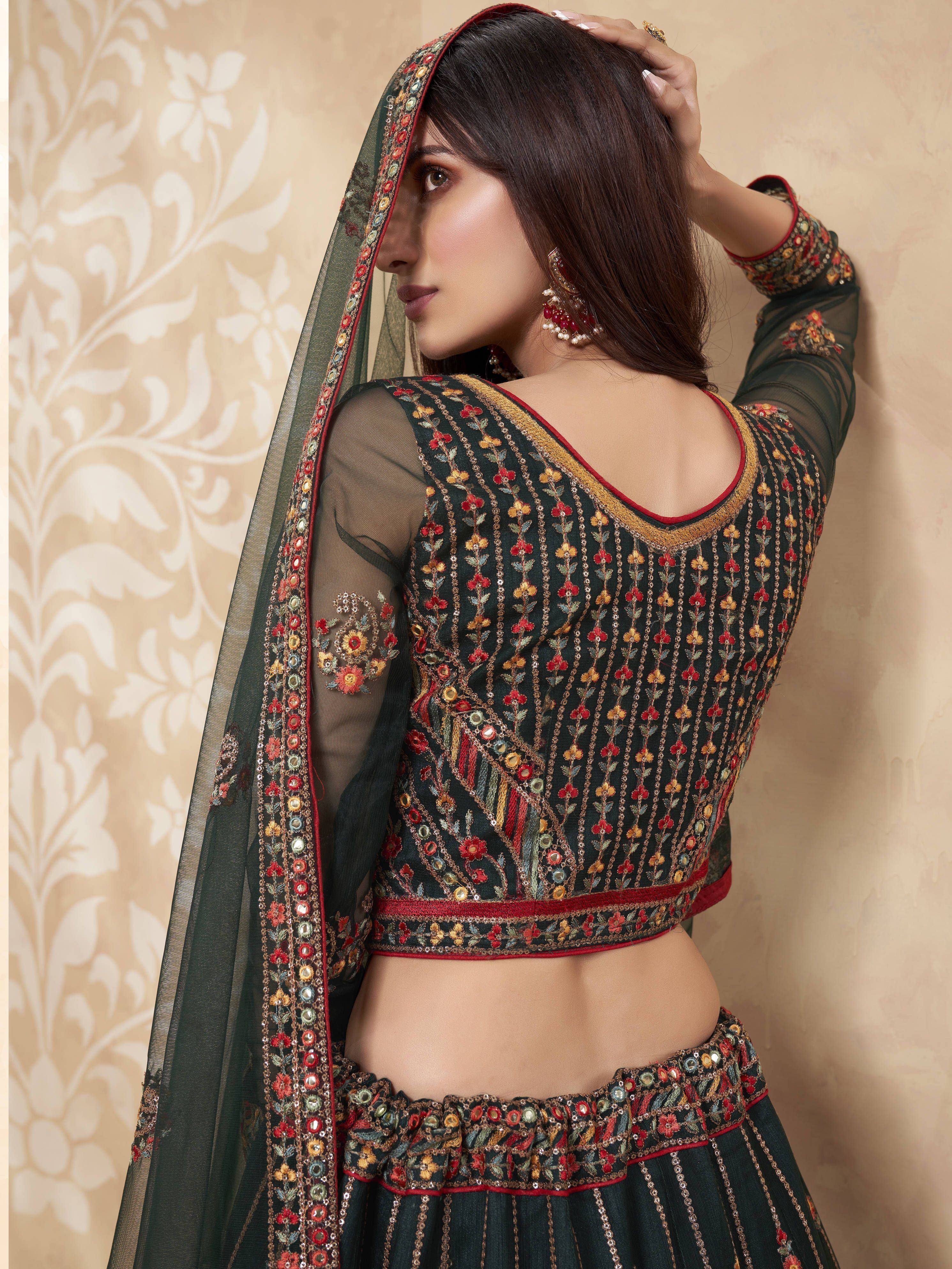 Elegant dark green embroidered lehenga choli with floral mirror work and sheer sleeves, perfect for Indian ethnic wear.