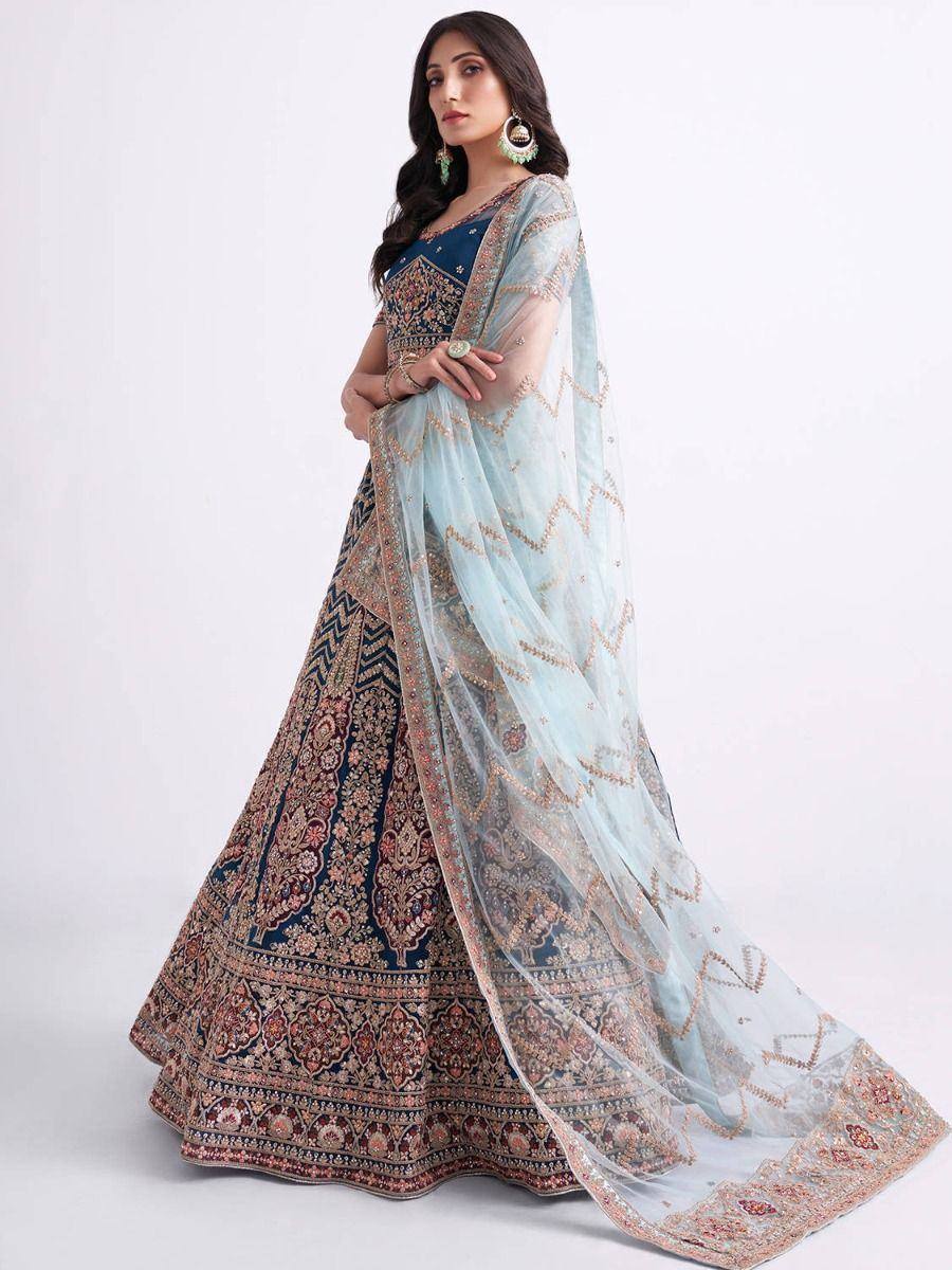 Elegant navy blue lehenga choli with intricate gold embroidery and light blue dupatta, perfect for weddings and festive occasions.