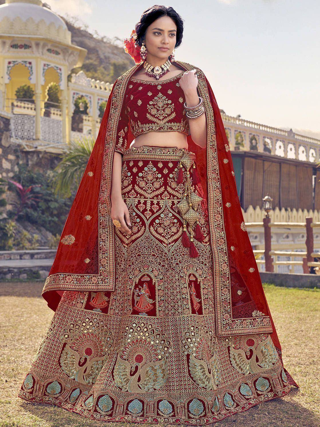 Red embroidered lehenga choli with peacock motifs, perfect for Indian weddings and festive occasions.