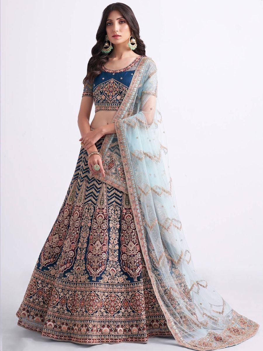 Elegant navy blue lehenga choli with intricate embroidery and sheer dupatta, perfect for Indian ethnic occasions.