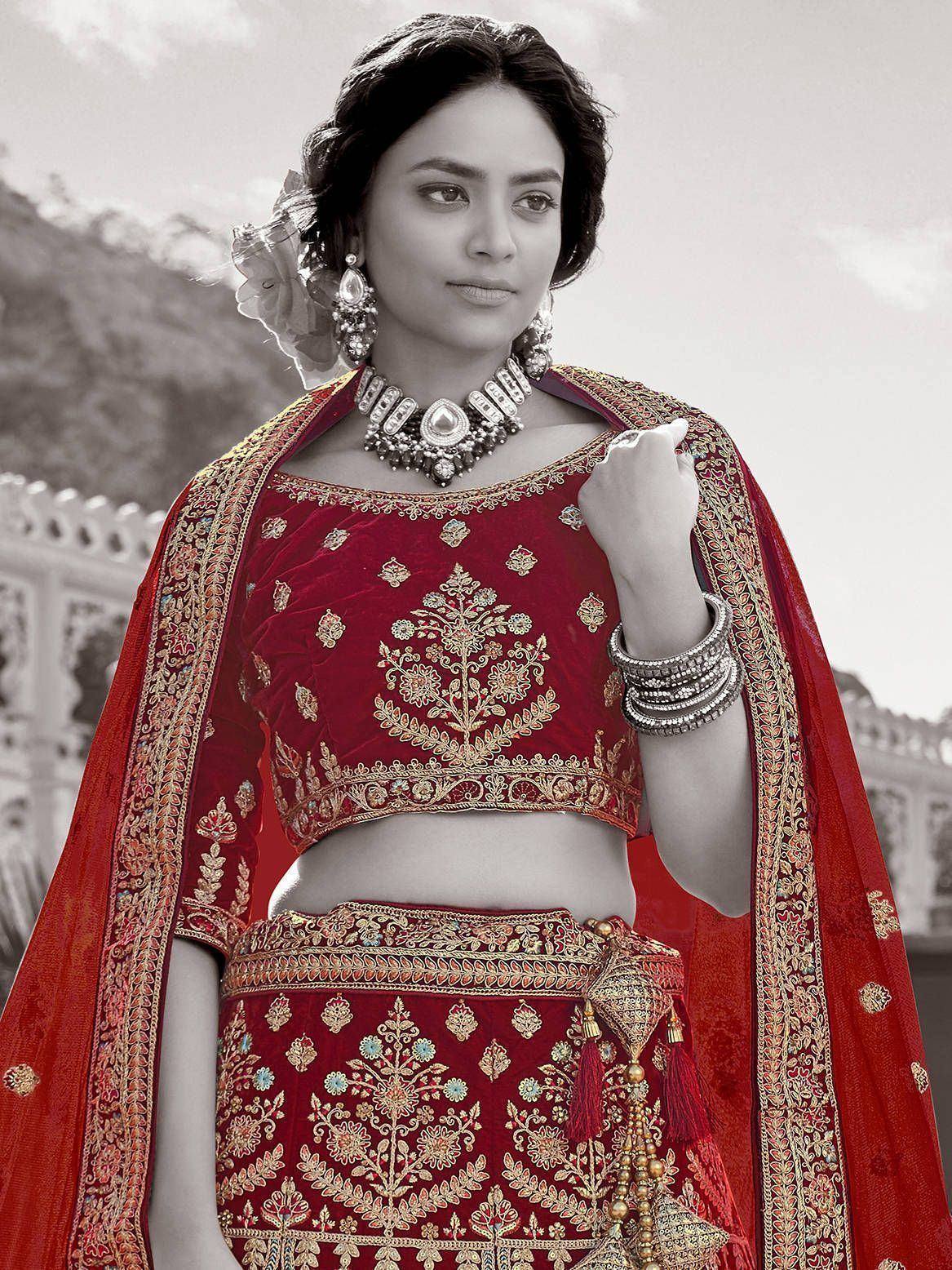 Red embroidered lehenga choli with gold detailing, traditional Indian ethnic wear for weddings and festivals