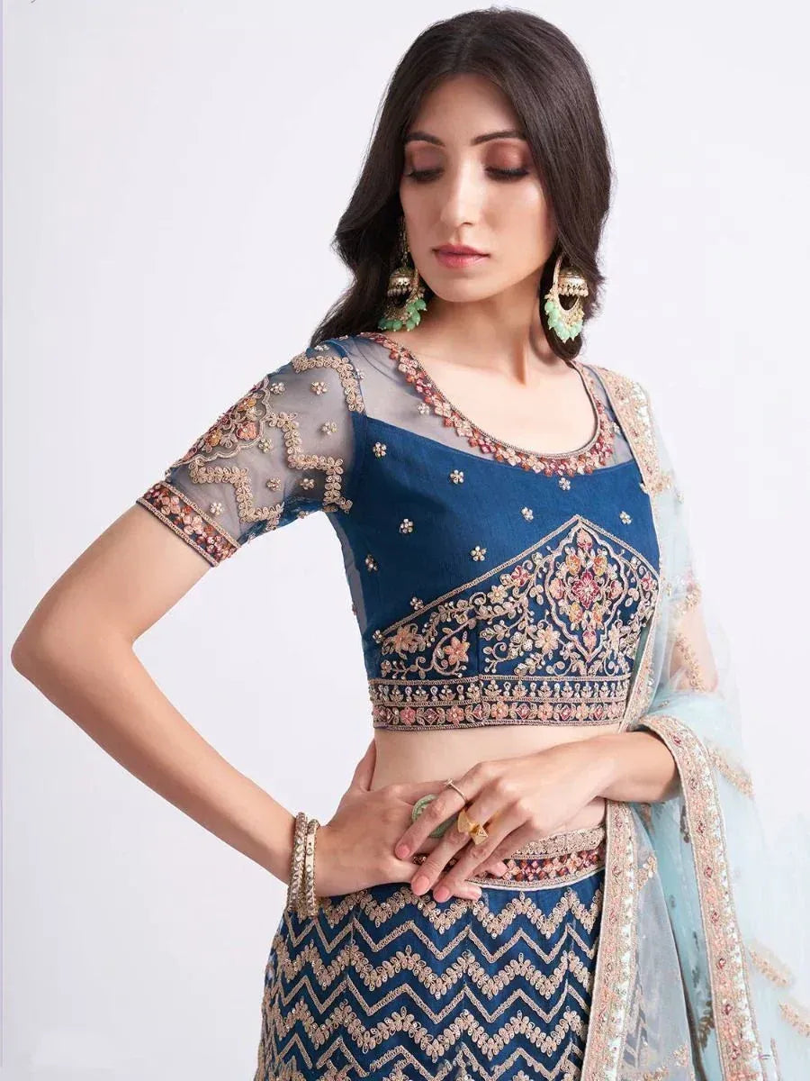 Blue embroidered lehenga choli with sheer sleeves and floral detailing, perfect for Indian ethnic wear