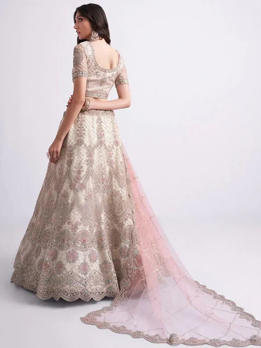Elegant beige embroidered lehenga choli with pink dupatta, perfect for Indian weddings and festive occasions.