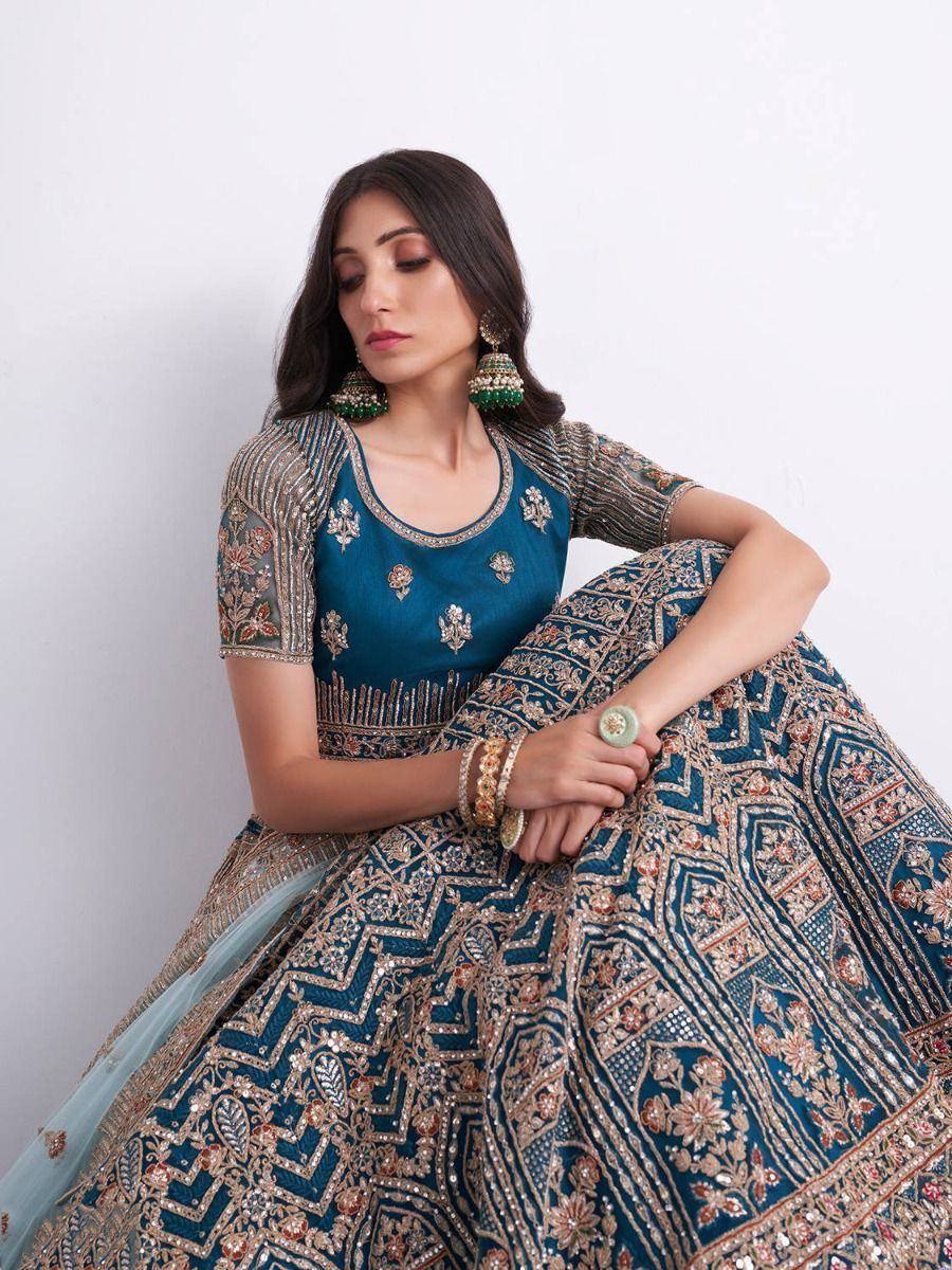 Elegant teal lehenga choli with intricate gold embroidery and floral motifs, perfect for Indian ethnic wear occasions.
