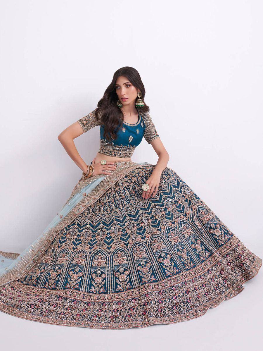 Blue embroidered lehenga choli with intricate gold and floral detailing, perfect for Indian weddings and festive occasions.