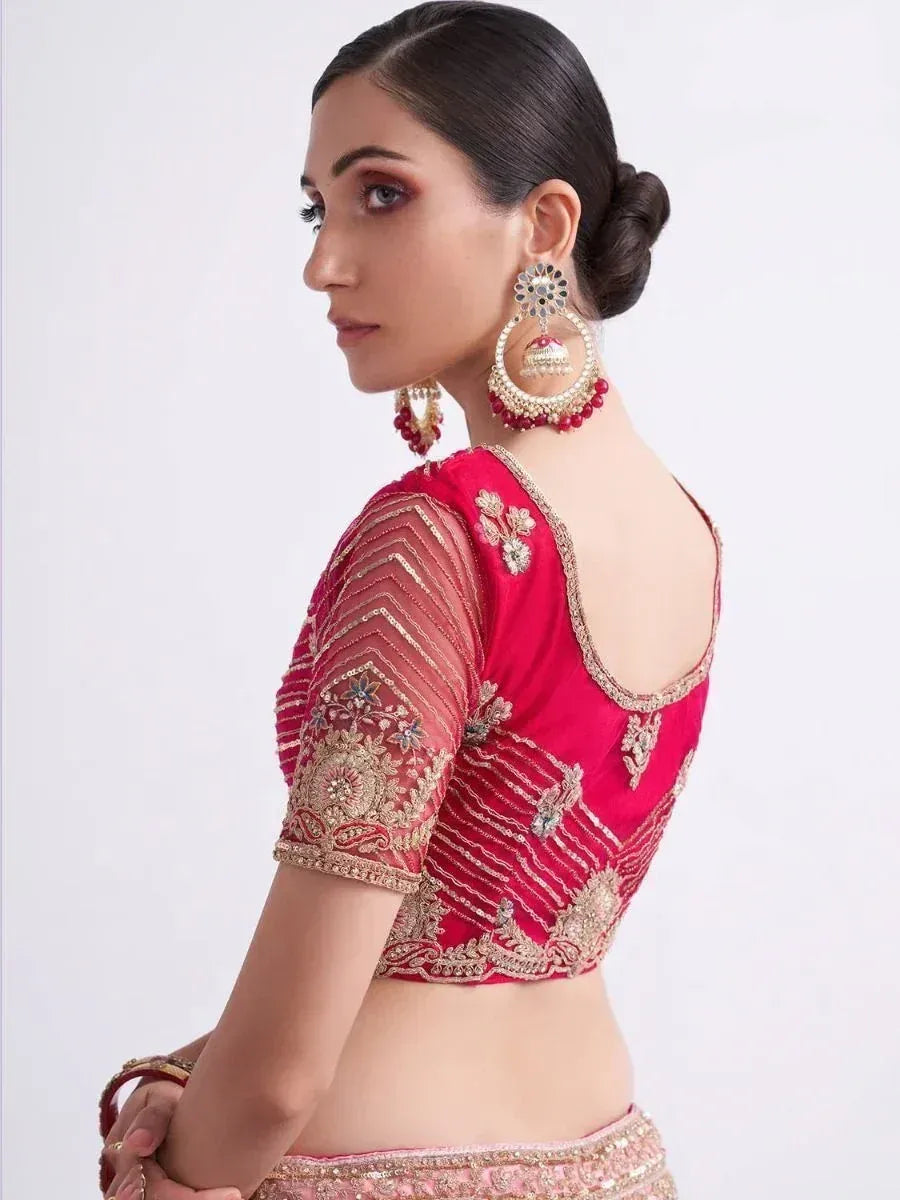 Red embroidered lehenga choli blouse with gold detailing and statement earrings