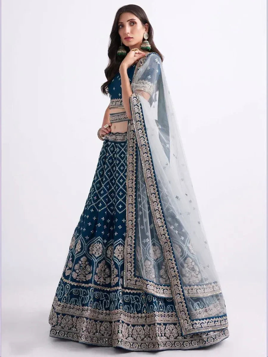 Elegant navy blue lehenga choli with intricate gold embroidery and sheer dupatta for Indian ethnic wear