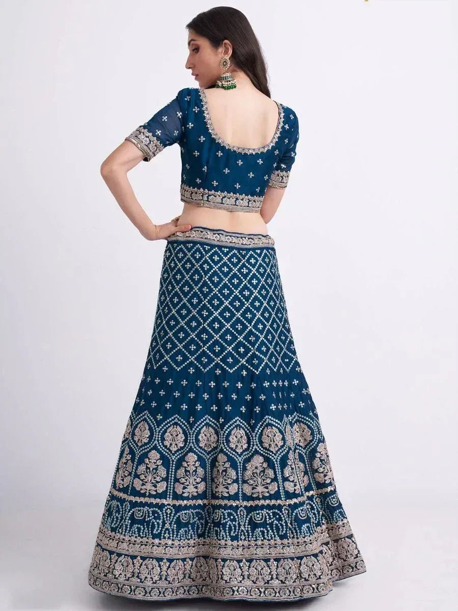 Blue embroidered lehenga choli with backless blouse and intricate silver work, perfect for Indian ethnic occasions